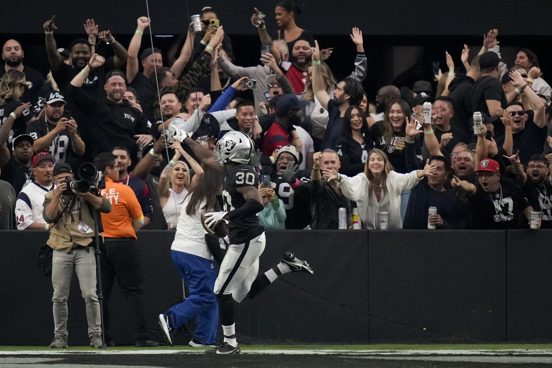 Las Vegas Raiders safety Duron Harmon- reacts with fans after scoring a touchdown off an interception during the second half of an NFL football game against the Houston Texans, Sunday, Oct. 23, 2022, in Las Vegas. (AP Photo/John Locher) Las Vegas Raiders safety Duron Harmon- reacts with fans after scoring a touchdown off an interception during the second half of an NFL football game against the Houston Texans, Sunday, Oct. 23, 2022, in Las Vegas. (AP Photo/John Locher)