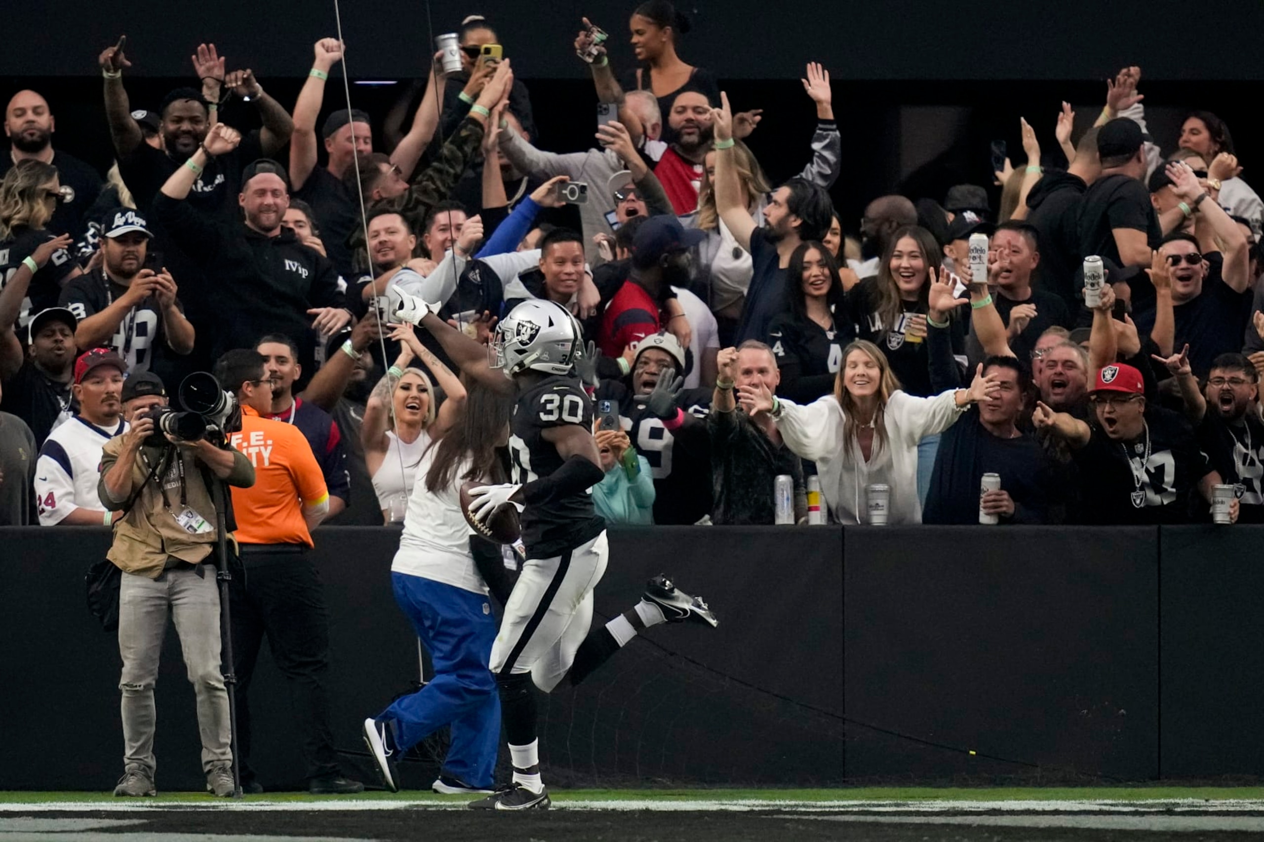 Las Vegas Raiders safety Duron Harmon- reacts with fans after scoring a touchdown off an interception during the second half of an NFL football game against the Houston Texans, Sunday, Oct. 23, 2022, in Las Vegas. (AP Photo/John Locher)
