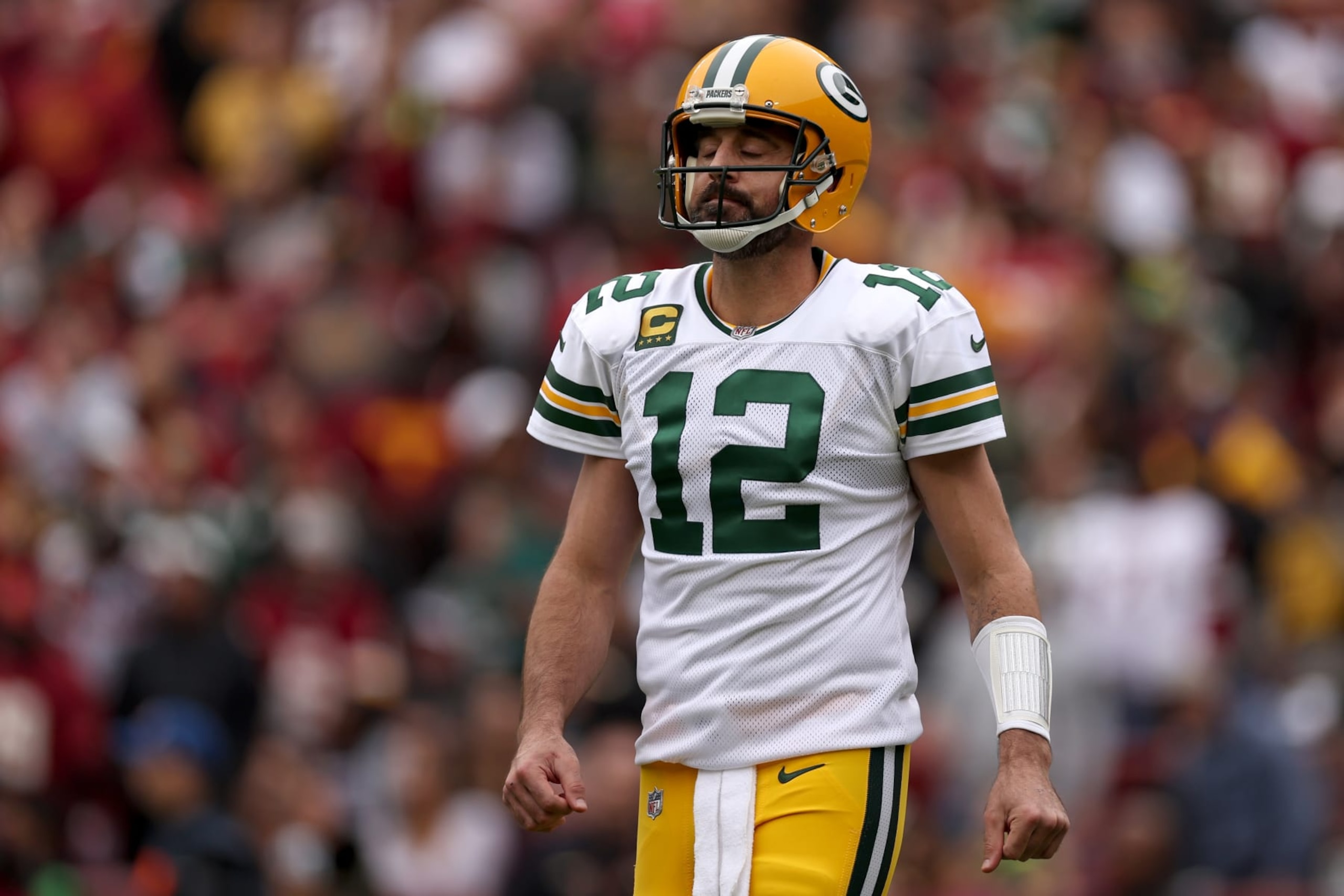 LANDOVER, MARYLAND - OCTOBER 23: Aaron Rodgers #12 of the Green Bay Packers reacts after a play during the first quarter of the game against the Washington Commanders at FedExField on October 23, 2022 in Landover, Maryland. (Photo by Scott Taetsch/Getty Images)