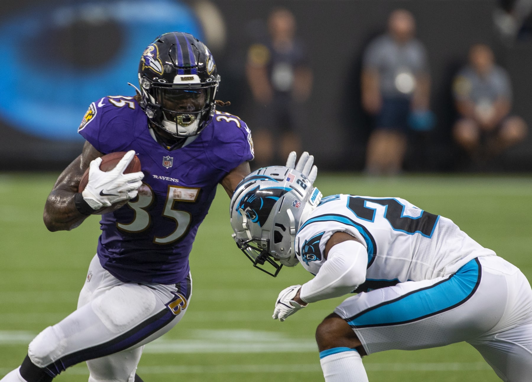CHARLOTTE, NC - AUGUST 21: Gus Edwards #35 of the Baltimore Ravens runs the ball against the Carolina Panthers during the first half of a NFL preseason game at Bank of America Stadium on August 21, 2021 in Charlotte, North Carolina. (Photo by Chris Keane/Getty Images)