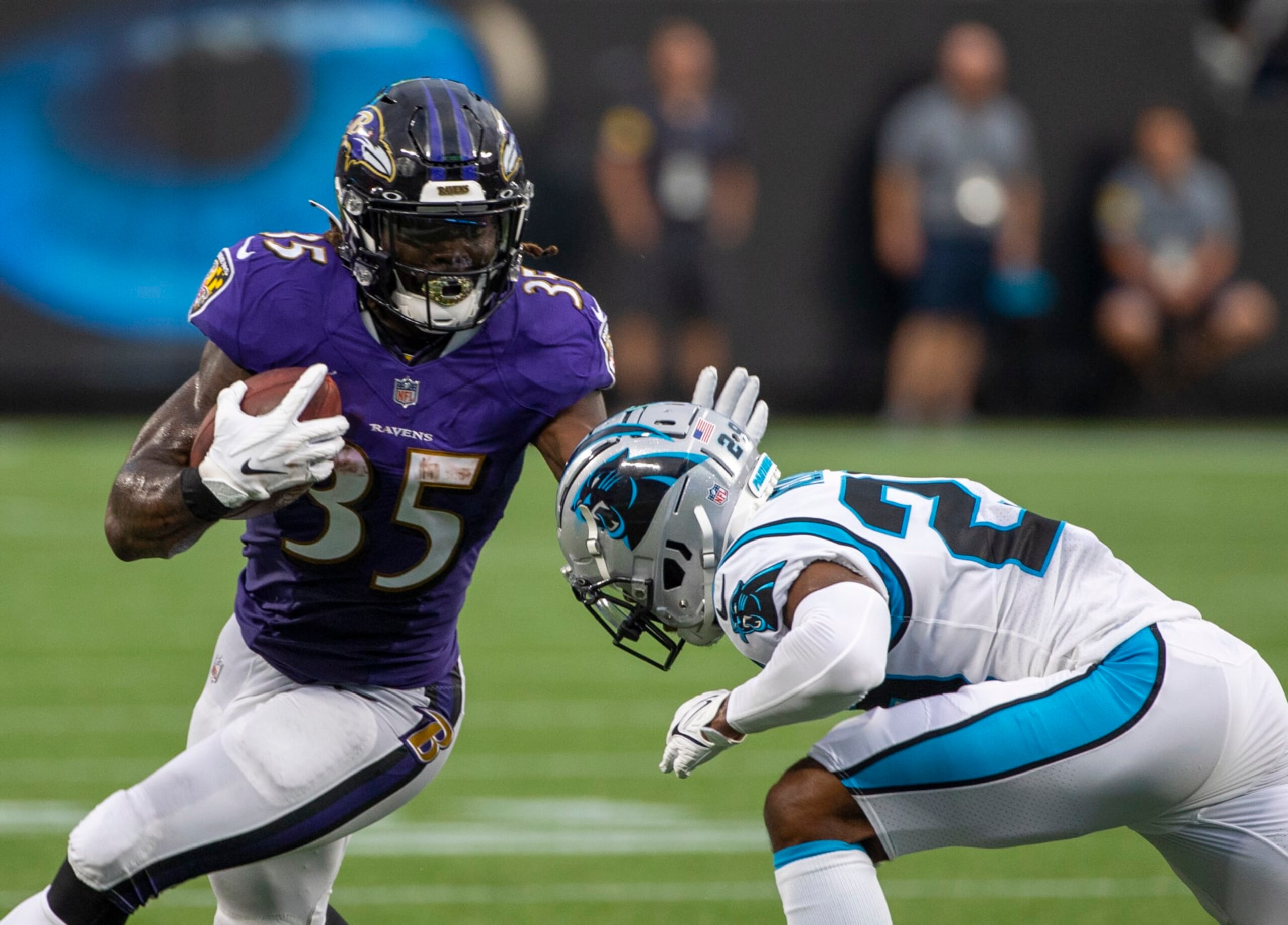 CHARLOTTE, NC - AUGUST 21: Gus Edwards #35 of the Baltimore Ravens runs the ball against the Carolina Panthers during the first half of a NFL preseason game at Bank of America Stadium on August 21, 2021 in Charlotte, North Carolina. (Photo by Chris Keane/Getty Images)