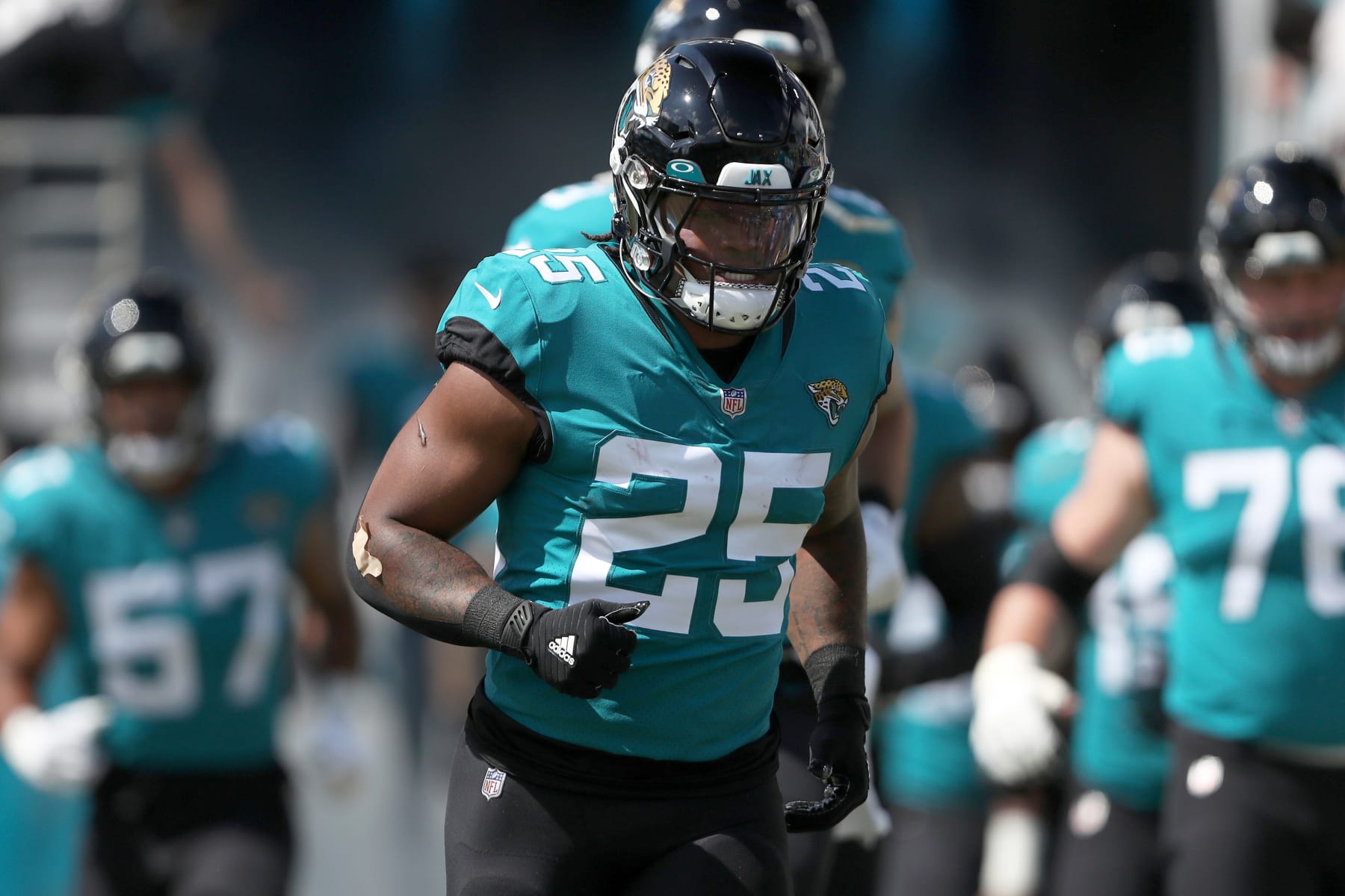 JACKSONVILLE, FLORIDA - OCTOBER 09: James Robinson #25 of the Jacksonville Jaguars enters the field before the game against the Houston Texans at TIAA Bank Field on October 09, 2022 in Jacksonville, Florida. (Photo by Courtney Culbreath/Getty Images)