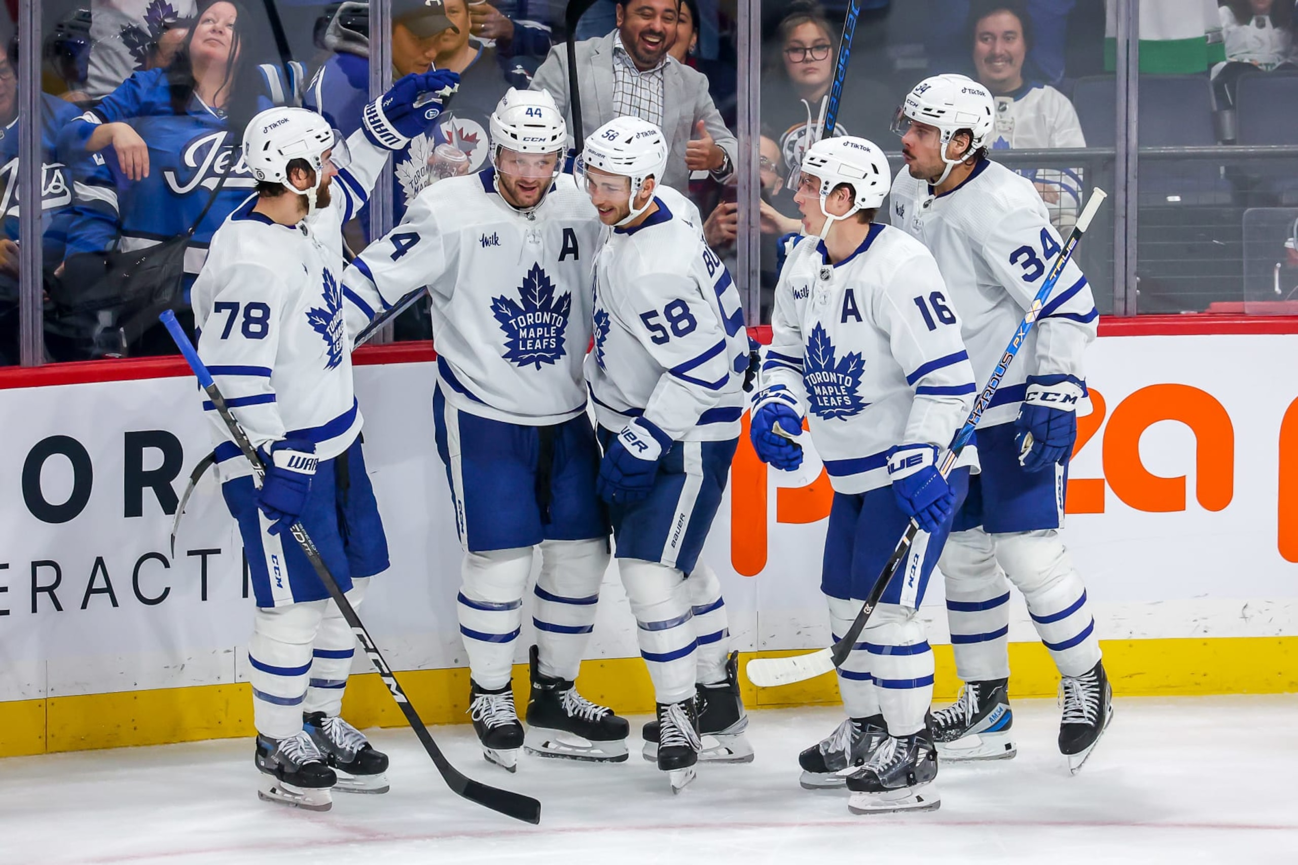 WINNIPEG, CANADA - OCTOBER 22: TJ Brodie #78, Morgan Rielly #44, Michael Bunting #58, Mitchell Marner #16 and Auston Matthews #34 of the Toronto Maple Leafs celebrate a third period empty net goal against the Winnipeg Jets at the Canada Life Centre on October 22, 2022 in Winnipeg, Manitoba, Canada. (Photo by Jonathan Kozub/NHLI via Getty Images)