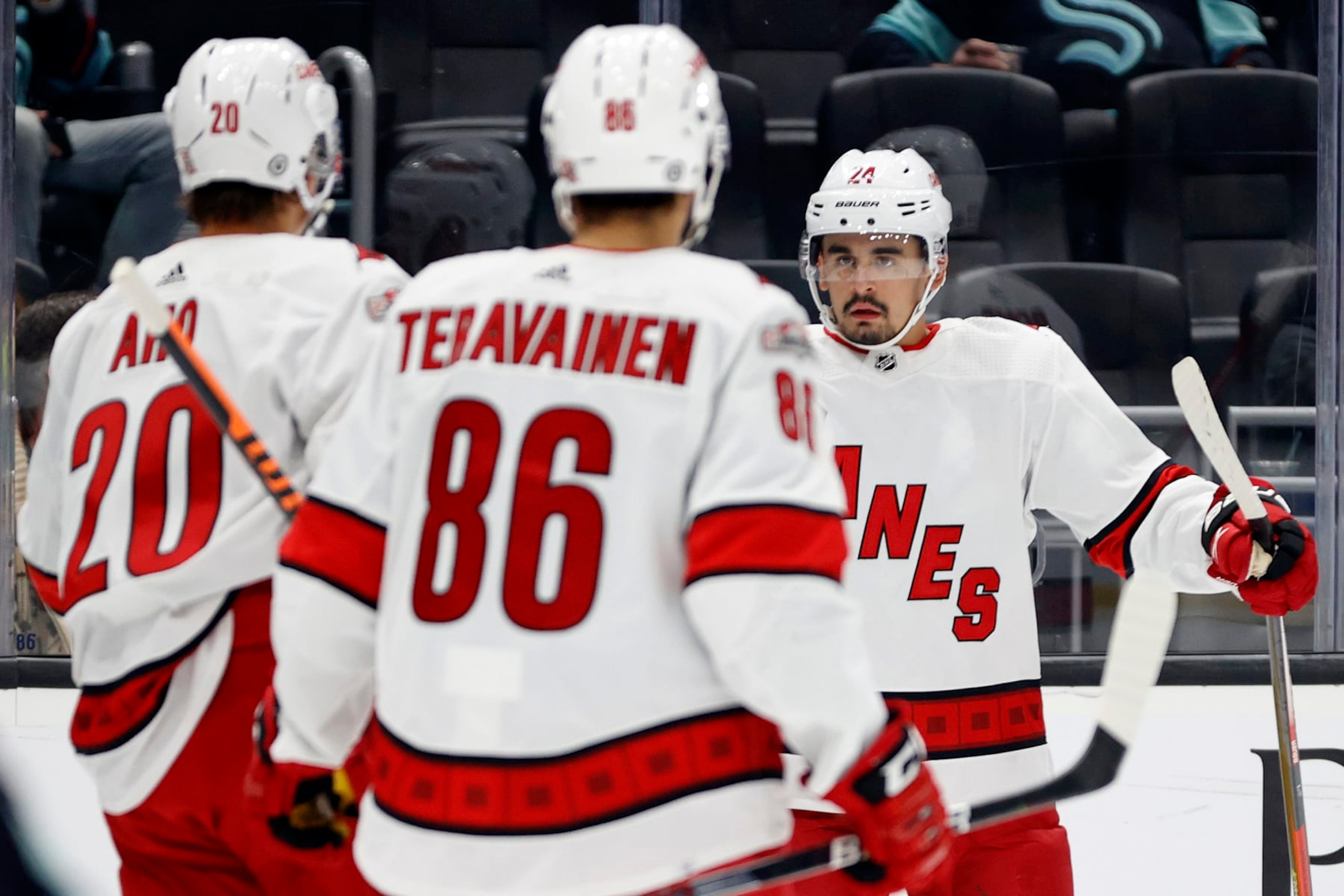 SEATTLE, WASHINGTON - OCTOBER 17: Seth Jarvis #24 of the Carolina Hurricanes celebrates his goal with Sebastian Aho #20 and Teuvo Teravainen #86 during the first period against the Seattle Kraken at Climate Pledge Arena on October 17, 2022 in Seattle, Washington. (Photo by Steph Chambers/Getty Images)