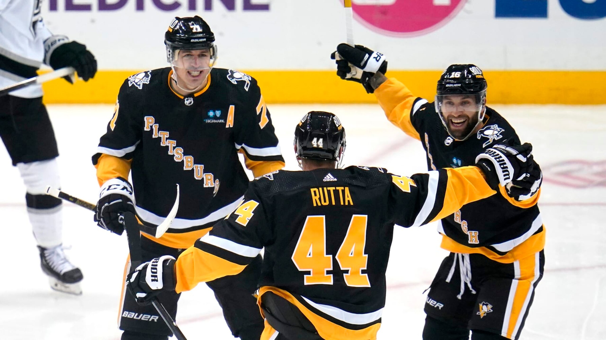 Pittsburgh Penguins' Jan Rutta (44) celebrates his goal against the Los Angeles Kings with Evgeni Malkin (71) and Jason Zucker (16) during the first period of an NHL hockey game in Pittsburgh, Thursday, Oct. 20, 2022. (AP Photo/Gene J. Puskar)