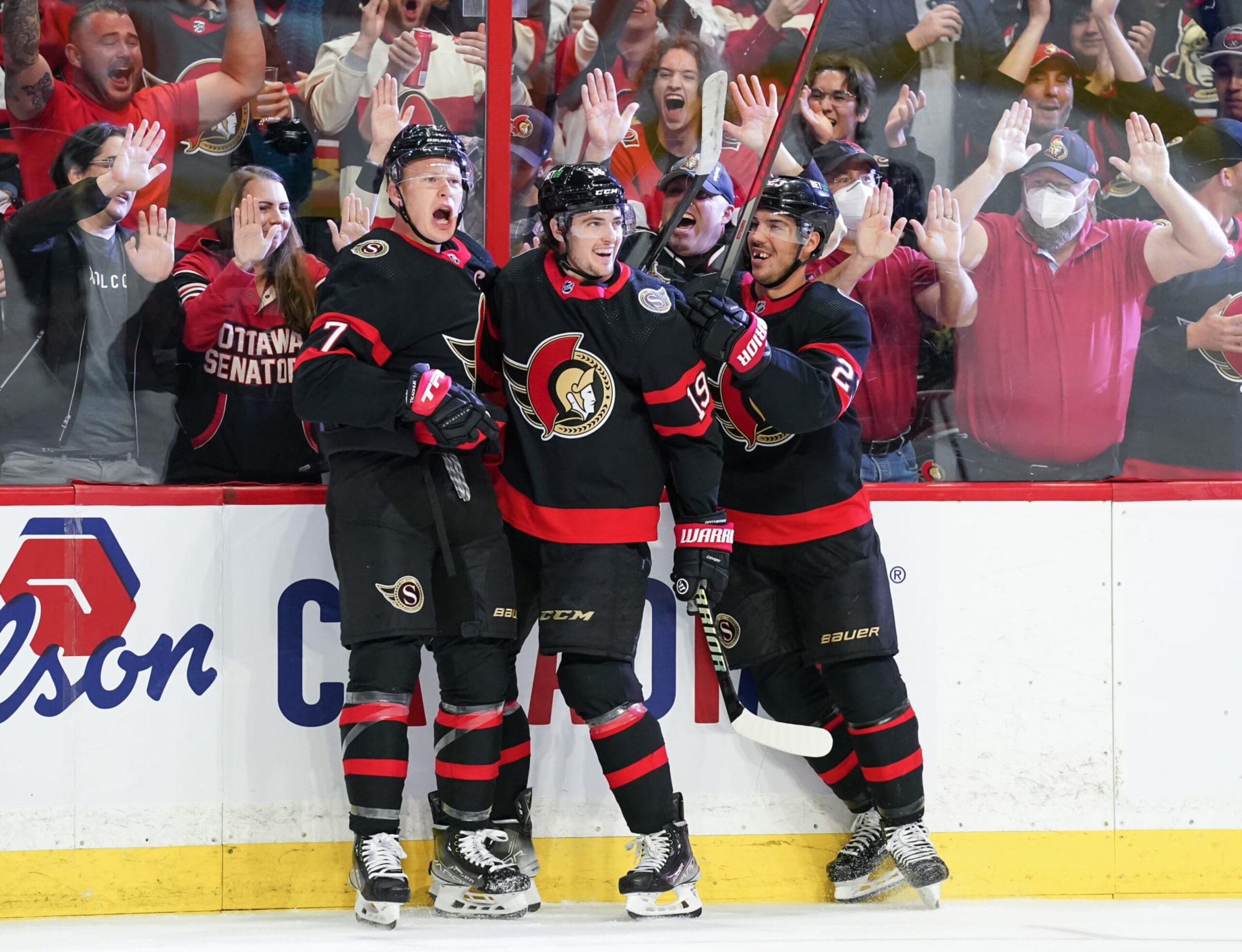 OTTAWA, CANADA - OCTOBER 18:  Brady Tkachuk #7 of the Ottawa Senators celebrates his second period goal with teammates Drake Batherson #19 and Travis Hamonic #23 against the Boston Bruins at Canadian Tire Centre on October 18, 2022 in Ottawa, Ontario, Canada.  (Photo by André Ringuette/NHLI via Getty Images)