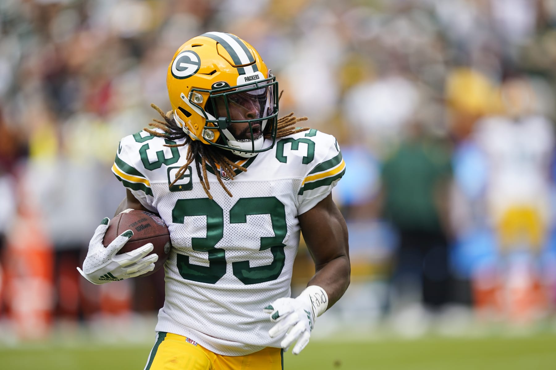 Green Bay Packers running back Aaron Jones (33) runs with ball during the first half of an NFL football game against the Washington Commanders, Sunday, Oct. 23, 2022, in Landover, Md. (AP Photo/Susan Walsh)