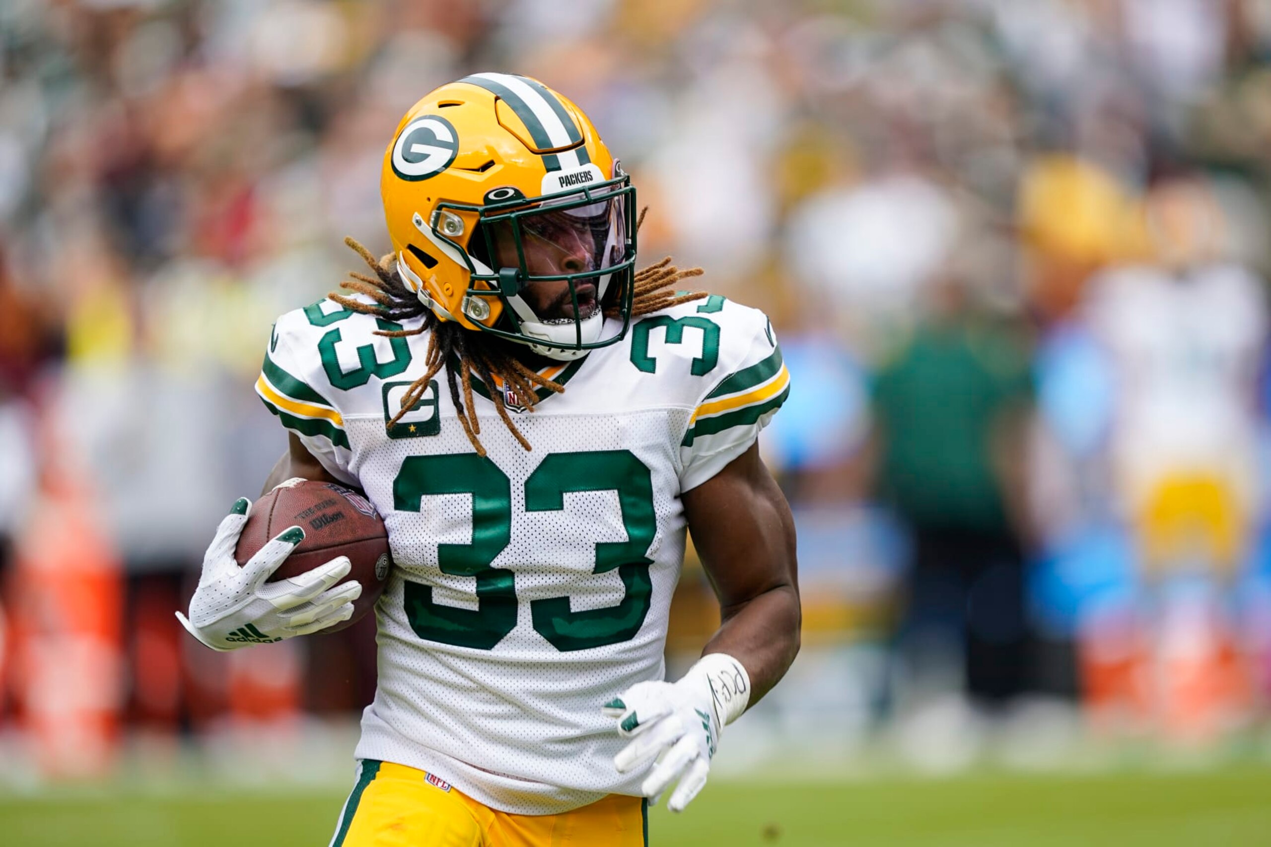 Green Bay Packers running back Aaron Jones (33) runs with ball during the first half of an NFL football game against the Washington Commanders, Sunday, Oct. 23, 2022, in Landover, Md. (AP Photo/Susan Walsh)