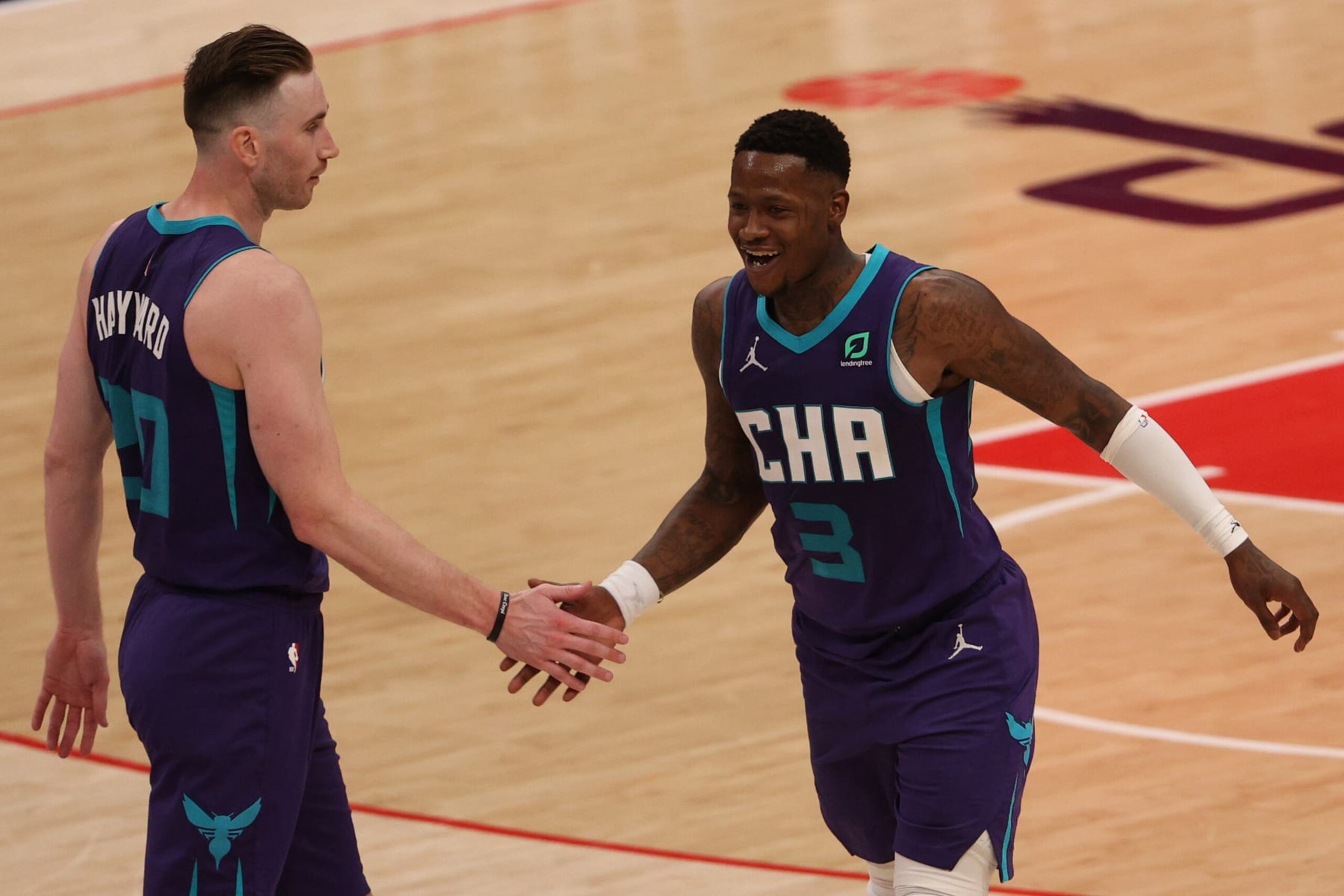WASHINGTON, DC - MARCH 30: Terry Rozier #3 and Gordon Hayward #20 of the Charlotte Hornets celebrate against the Washington Wizards during the second half at Capital One Arena on March 30, 2021 in Washington, DC. NOTE TO USER: User expressly acknowledges and agrees that, by downloading and or using this photograph, User is consenting to the terms and conditions of the Getty Images License Agreement. (Photo by Patrick Smith/Getty Images)