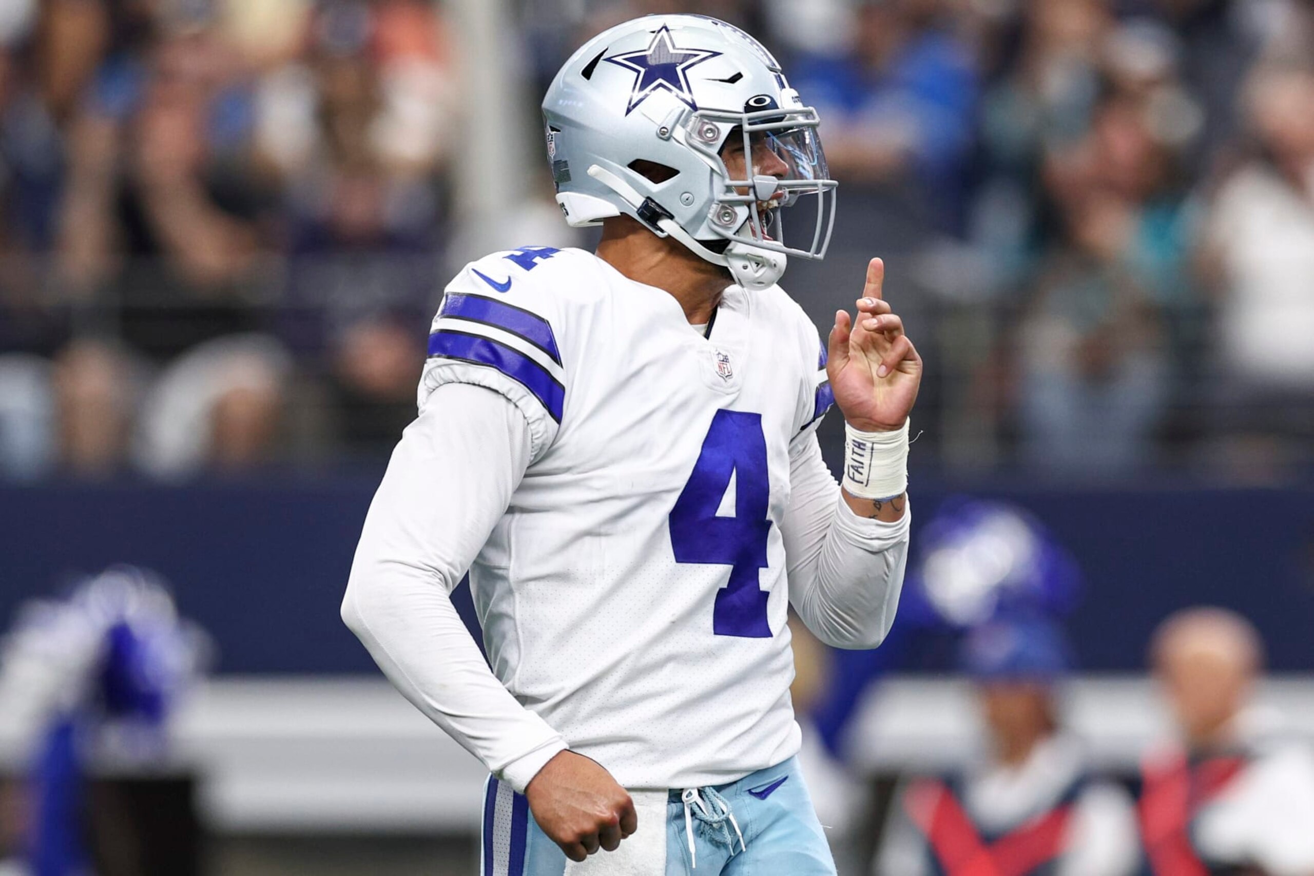 ARLINGTON, TEXAS - OCTOBER 23: Dak Prescott #4 of the Dallas Cowboys reacts after Ezekiel Elliott #21 (not pictured) scored a touchdown against the Detroit Lions during the first quarter at AT&T Stadium on October 23, 2022 in Arlington, Texas. (Photo by Tom Pennington/Getty Images)