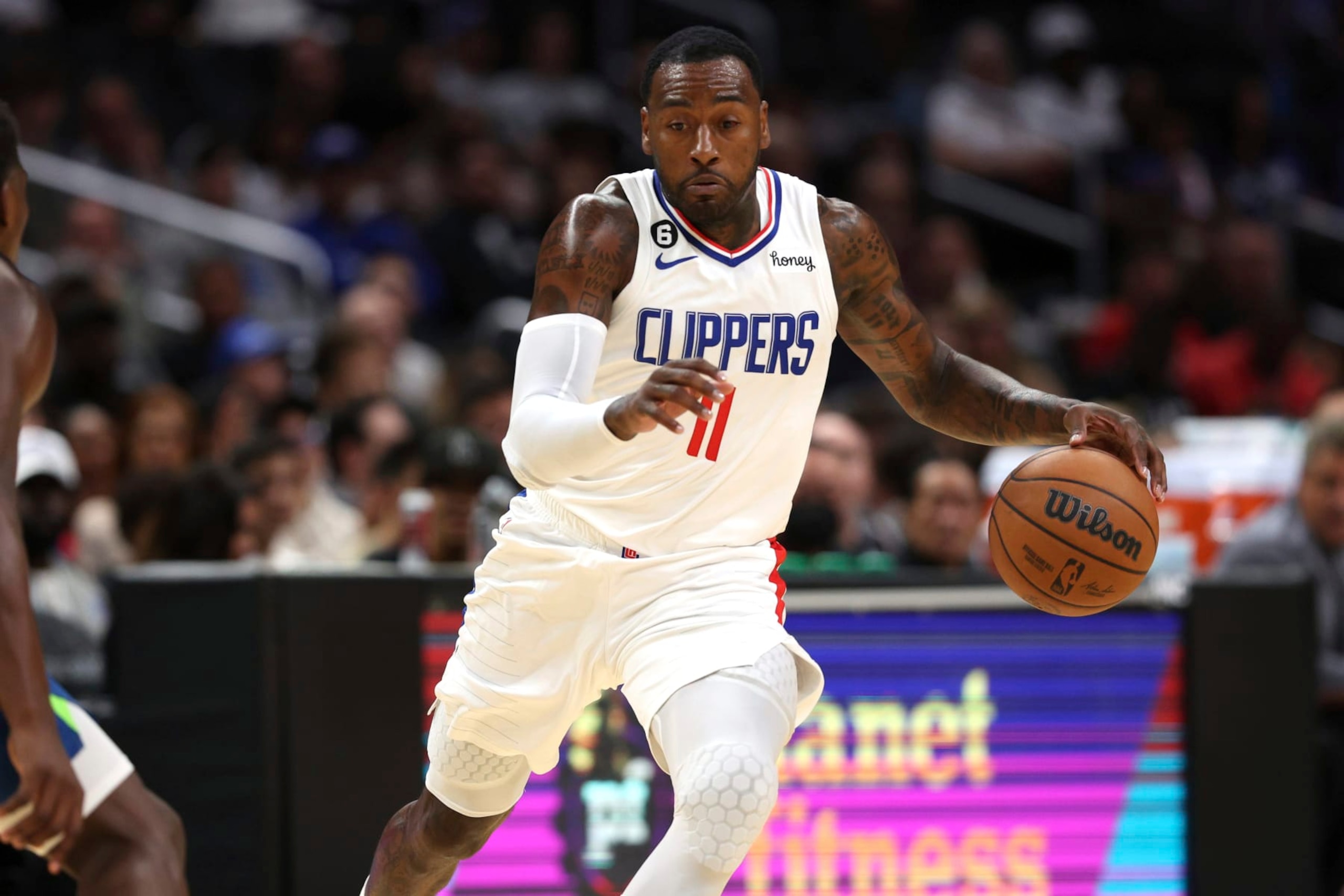 Los Angeles Clippers guard John Wall dribbles during the first half of an NBA preseason basketball game against the Minnesota Timberwolves, Sunday, Oct. 9, 2022, in Los Angeles. (AP Photo/Raul Romero Jr.)