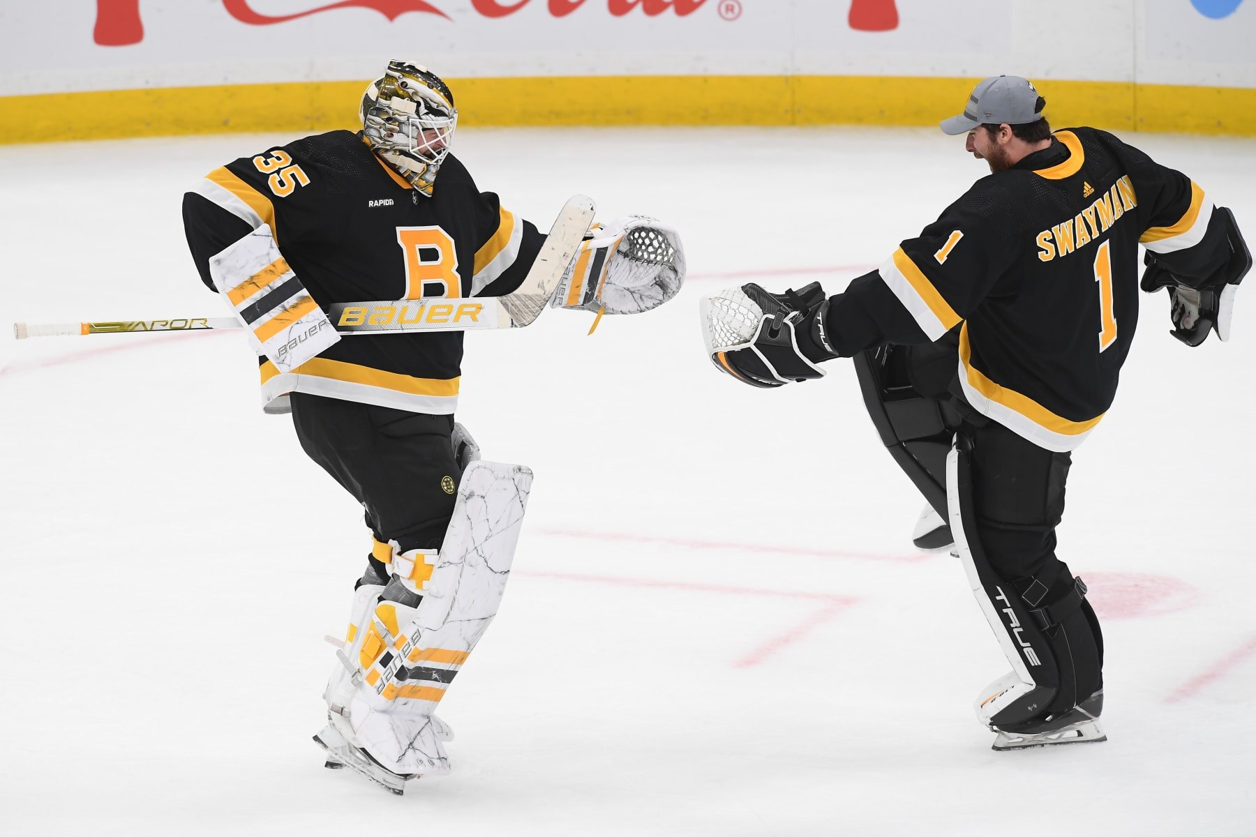 BOSTON, MASSACHUSETTS - OCTOBER 22: Linus Ullmark #35 and Jeremy Swayman #1 of the Boston Bruins celebrate the overtime win against the Minnesota Wild at the TD Garden on October 22, 2022 in Boston, Massachusetts. (Photo by Steve Babineau/NHLI via Getty Images)