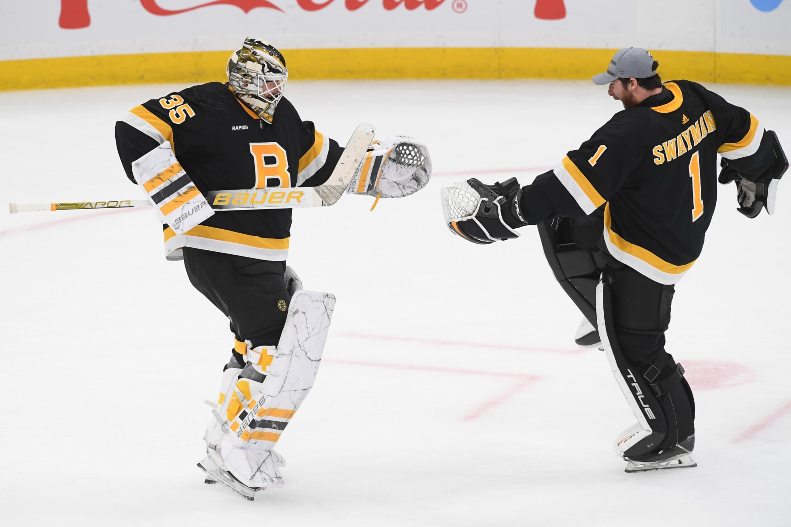 BOSTON, MASSACHUSETTS - OCTOBER 22: Linus Ullmark #35 and Jeremy Swayman #1 of the Boston Bruins celebrate the overtime win against the Minnesota Wild at the TD Garden on October 22, 2022 in Boston, Massachusetts. (Photo by Steve Babineau/NHLI via Getty Images)