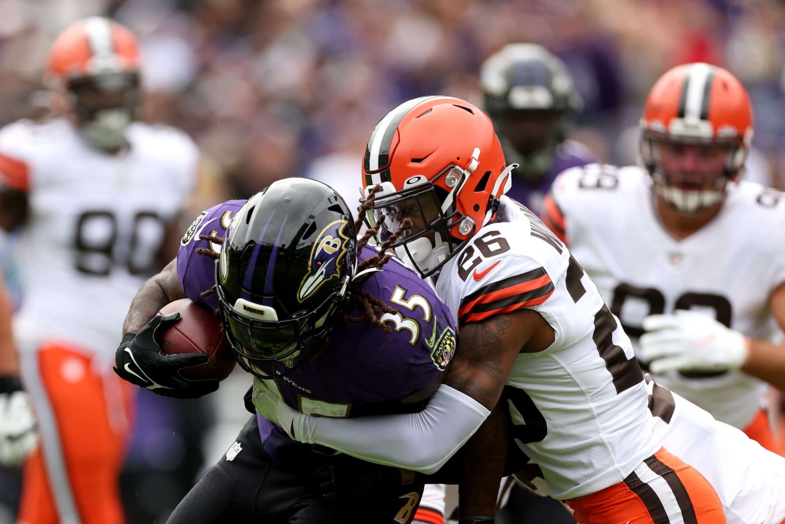 BALTIMORE, MARYLAND - OCTOBER 23: Running back Gus Edwards #35 of the Baltimore Ravens is tackled by cornerback Greedy Williams #26 of the Cleveland Browns at M&T Bank Stadium on October 23, 2022 in Baltimore, Maryland. (Photo by Rob Carr/Getty Images)