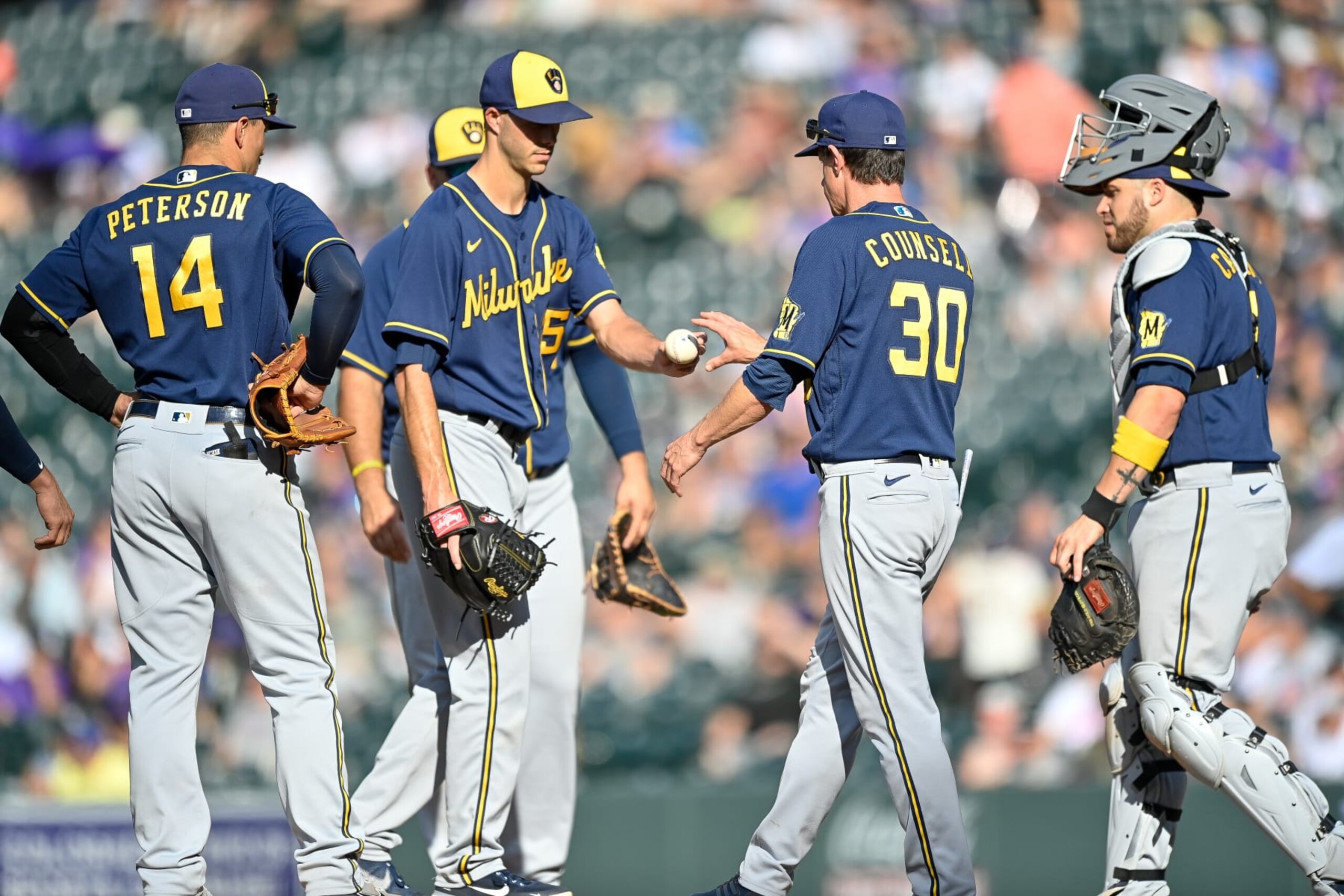 DENVER, CO - SEPTEMBER 5: Craig Counsell #30 of the Milwaukee Brewers relieves Taylor Rogers #25 in the eighth inning of a game against the Colorado Rockies at Coors Field on September 5, 2022 in Denver, Colorado. (Photo by Dustin Bradford/Getty Images)