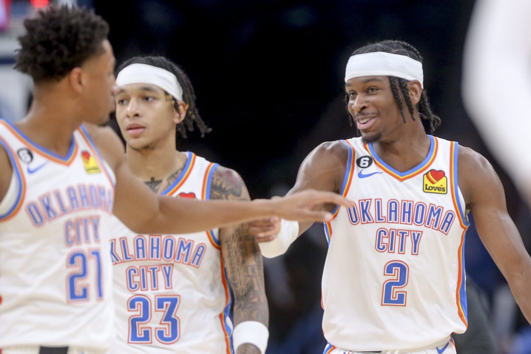 OKLAHOMA CITY, OKLAHOMA - OCTOBER 25: Shai Gilgeous-Alexander #2, Aaron Wiggins #21 and Tre Mann #23 of the Oklahoma City Thunder celebrate during a timeout in the third quarter against the Los Angeles Clippers at Paycom Center on October 25, 2022 in Oklahoma City, Oklahoma. NOTE TO USER: User expressly acknowledges and agrees that, by downloading and or using this photograph, User is consenting to the terms and conditions of the Getty Images License Agreement.  (Photo by Ian Maule/Getty Images)