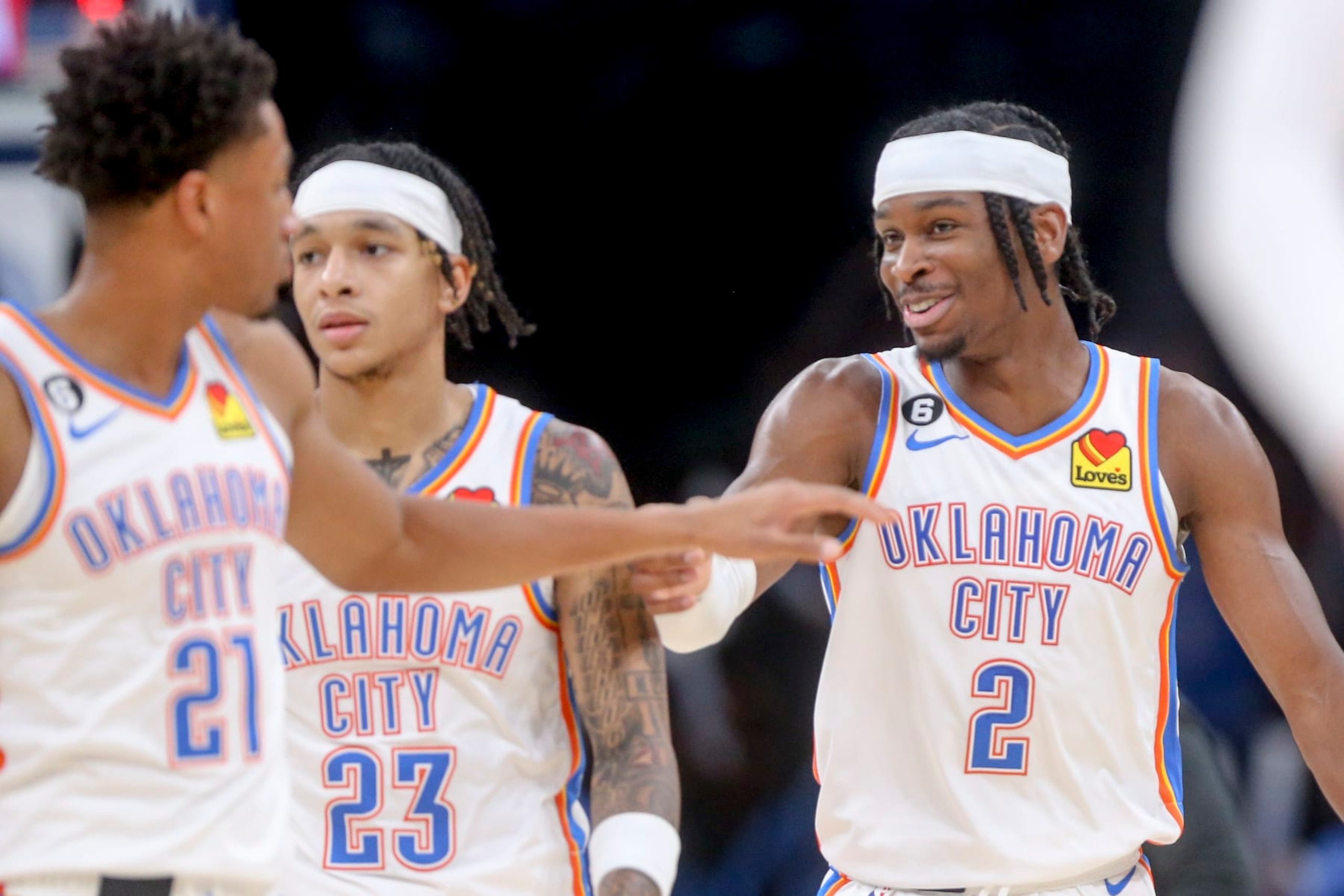 OKLAHOMA CITY, OKLAHOMA - OCTOBER 25: Shai Gilgeous-Alexander #2, Aaron Wiggins #21 and Tre Mann #23 of the Oklahoma City Thunder celebrate during a timeout in the third quarter against the Los Angeles Clippers at Paycom Center on October 25, 2022 in Oklahoma City, Oklahoma. NOTE TO USER: User expressly acknowledges and agrees that, by downloading and or using this photograph, User is consenting to the terms and conditions of the Getty Images License Agreement.  (Photo by Ian Maule/Getty Images)