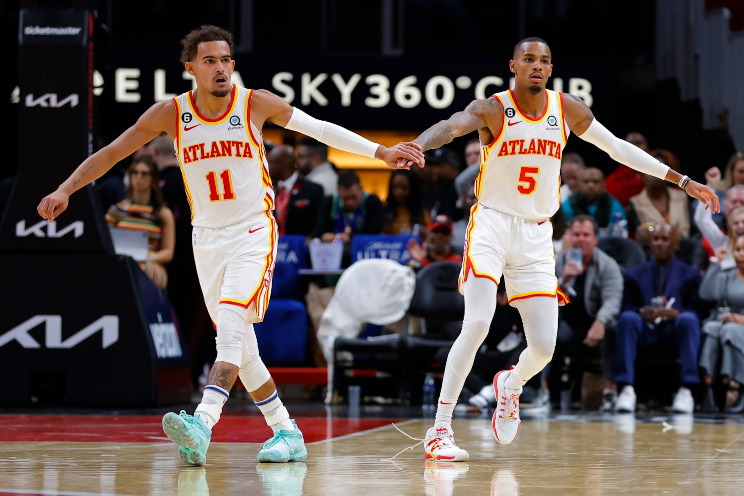 ATLANTA, GA - OCTOBER 21: Trae Young #11 reacts with Dejounte Murray #5 of the Atlanta Hawks during the second half against the Orlando Magic at State Farm Arena on October 21, 2022 in Atlanta, Georgia. NOTE TO USER: User expressly acknowledges and agrees that, by downloading and or using this photograph, User is consenting to the terms and conditions of the Getty Images License Agreement. (Photo by Todd Kirkland/Getty Images)