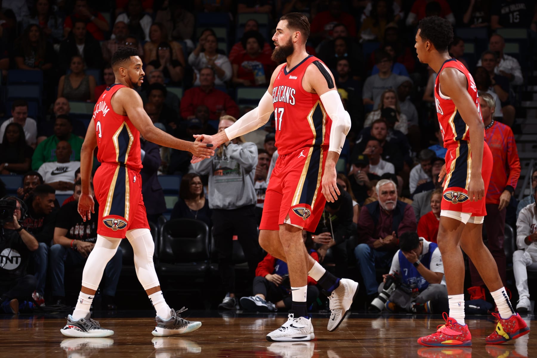 NEW ORLEANS, LA - OCTOBER 25: CJ McCollum #3 high fives Jonas Valanciunas #17 of the New Orleans Pelicans during the game against the Dallas Mavericks on October 25, 2022 at the Smoothie King Center in New Orleans, Louisiana. NOTE TO USER: User expressly acknowledges and agrees that, by downloading and or using this Photograph, user is consenting to the terms and conditions of the Getty Images License Agreement. Mandatory Copyright Notice: Copyright 2022 NBAE (Photo by Ned Dishman/NBAE via Getty Images)