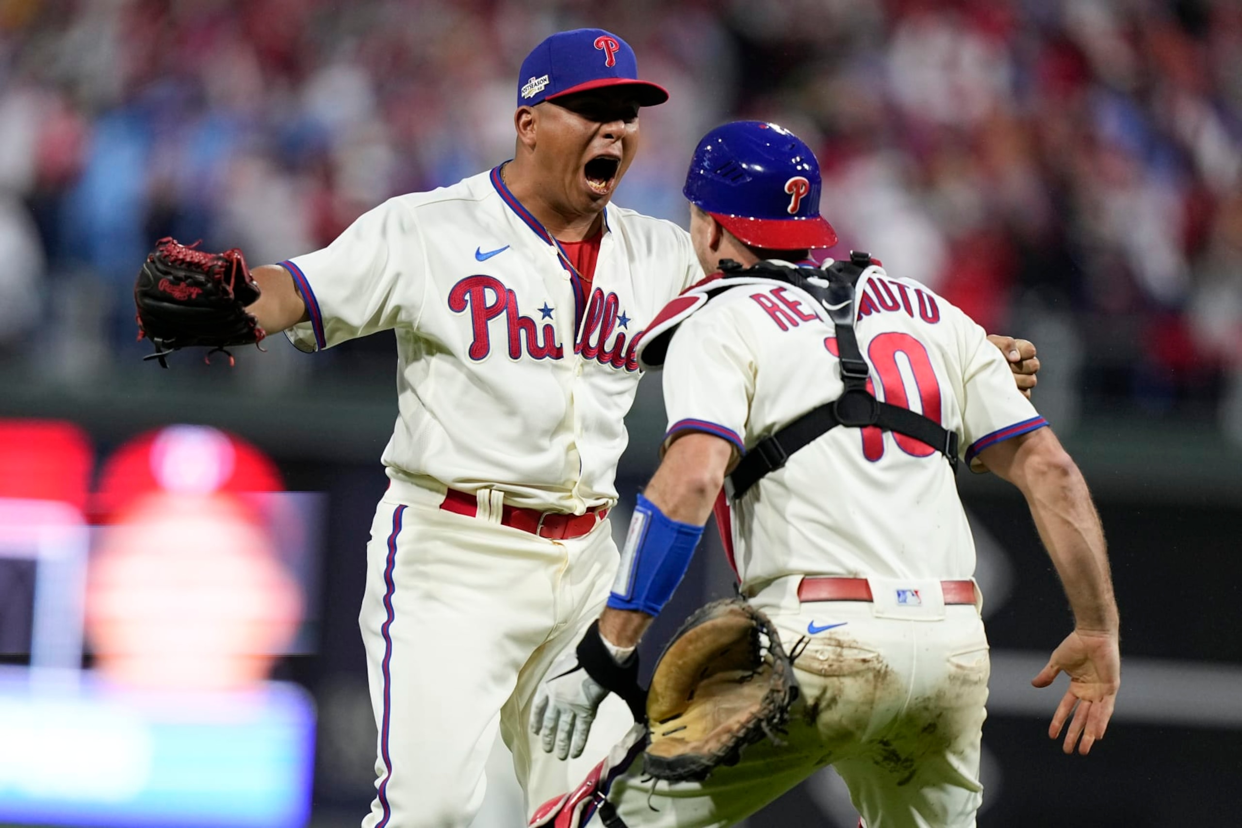 Philadelphia Phillies pitcher Ranger Suarez and catcher J.T. Realmuto celebrate after winning the baseball NL Championship Series against the San Diego Padres on Sunday, Oct. 23, 2022, in Philadelphia. (AP Photo/Brynn Anderson)