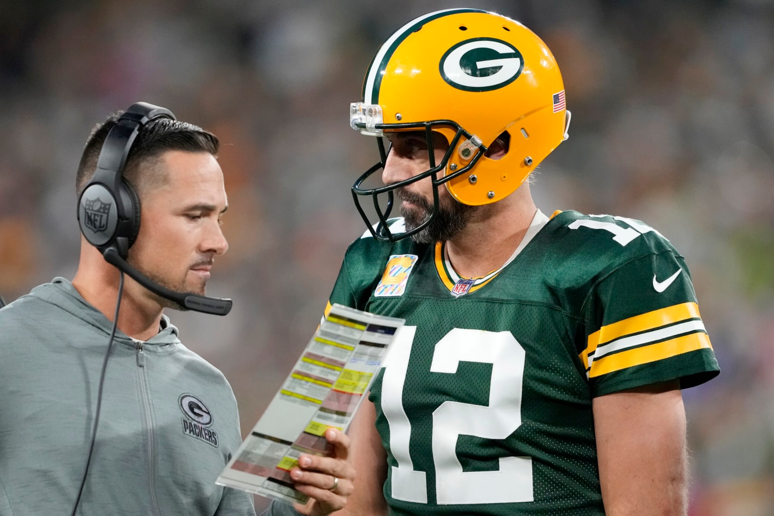 GREEN BAY, WISCONSIN - OCTOBER 02: Head coach Matt LaFleur of the Green Bay Packers talks to Aaron Rodgers #12 of the Green Bay Packers during overtime against the New England Patriots at Lambeau Field on October 02, 2022 in Green Bay, Wisconsin. (Photo by Patrick McDermott/Getty Images)