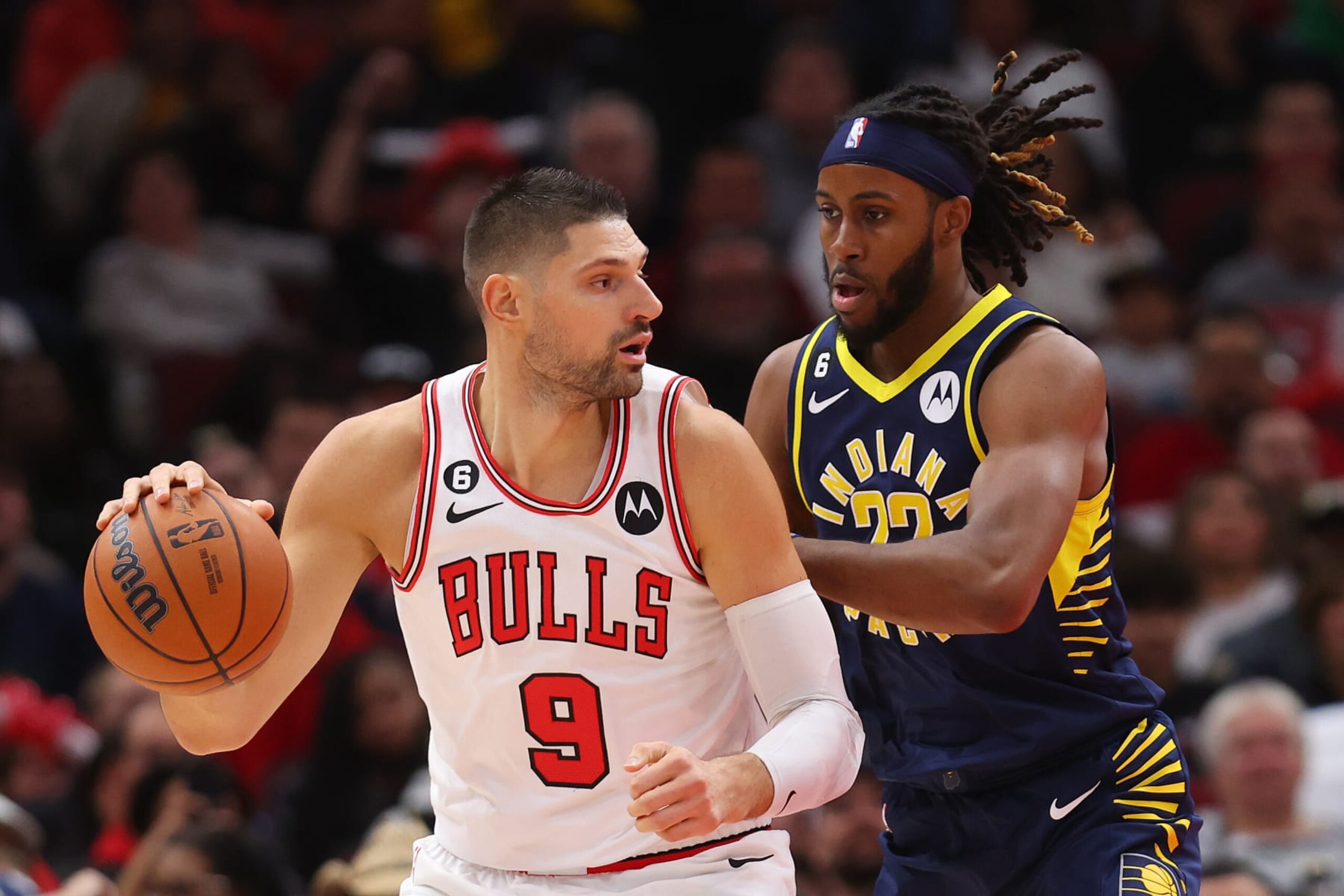CHICAGO, ILLINOIS - OCTOBER 26: Nikola Vucevic #9 of the Chicago Bulls is defended by Isaiah Jackson #22 of the Indiana Pacers during the first half at United Center on October 26, 2022 in Chicago, Illinois. NOTE TO USER: User expressly acknowledges and agrees that, by downloading and or using this photograph, User is consenting to the terms and conditions of the Getty Images License Agreement. (Photo by Michael Reaves/Getty Images)