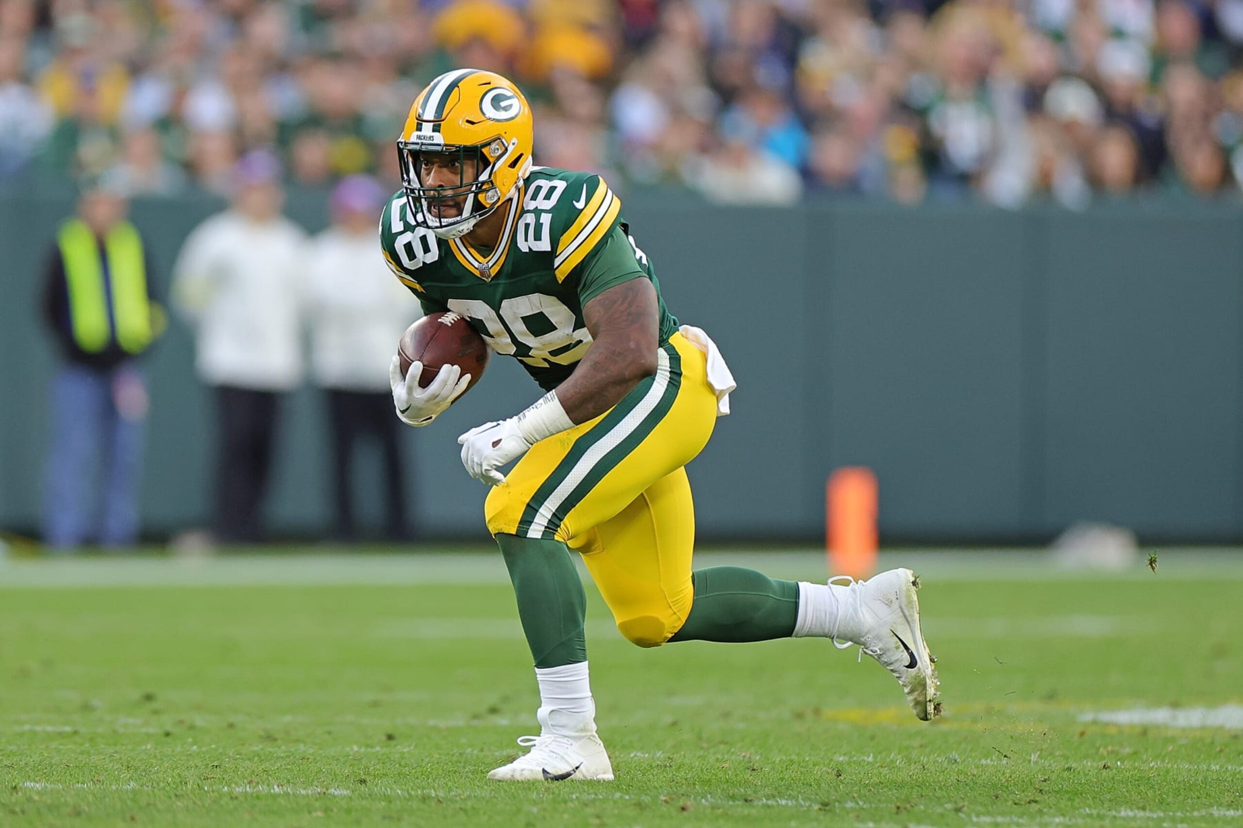GREEN BAY, WISCONSIN - OCTOBER 02: AJ Dillon #28 of the Green Bay Packers runs for yards during a game against the New England Patriots at Lambeau Field on October 02, 2022 in Green Bay, Wisconsin.  The Packers defeated the Patriots 27-24 in overtime. (Photo by Stacy Revere/Getty Images)