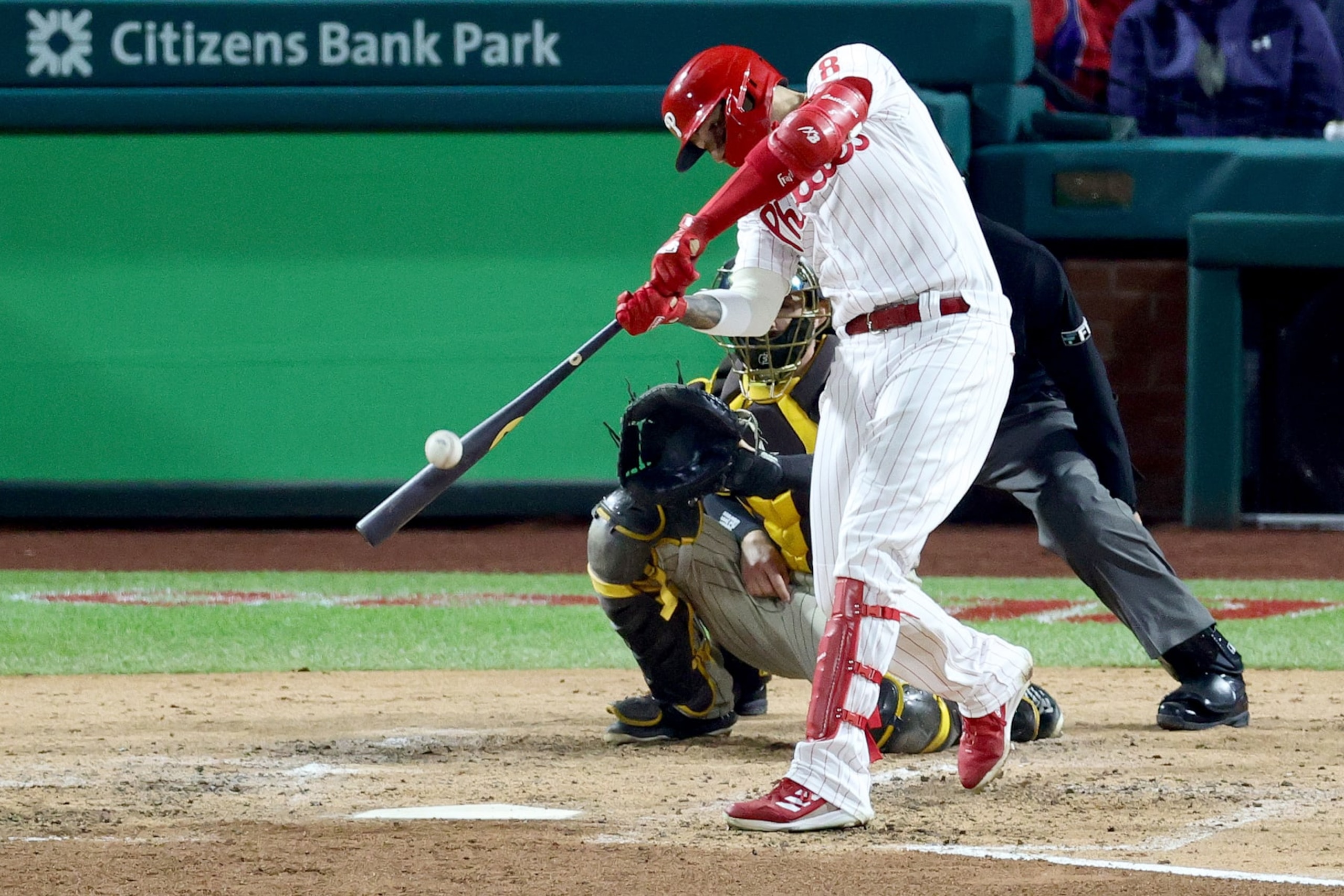 PHILADELPHIA, PENNSYLVANIA - OCTOBER 22: Nick Castellanos #8 of the Philadelphia Phillies hits a double during the fourth inning against the San Diego Padres in game four of the National League Championship Series at Citizens Bank Park on October 22, 2022 in Philadelphia, Pennsylvania. (Photo by Tim Nwachukwu/Getty Images)