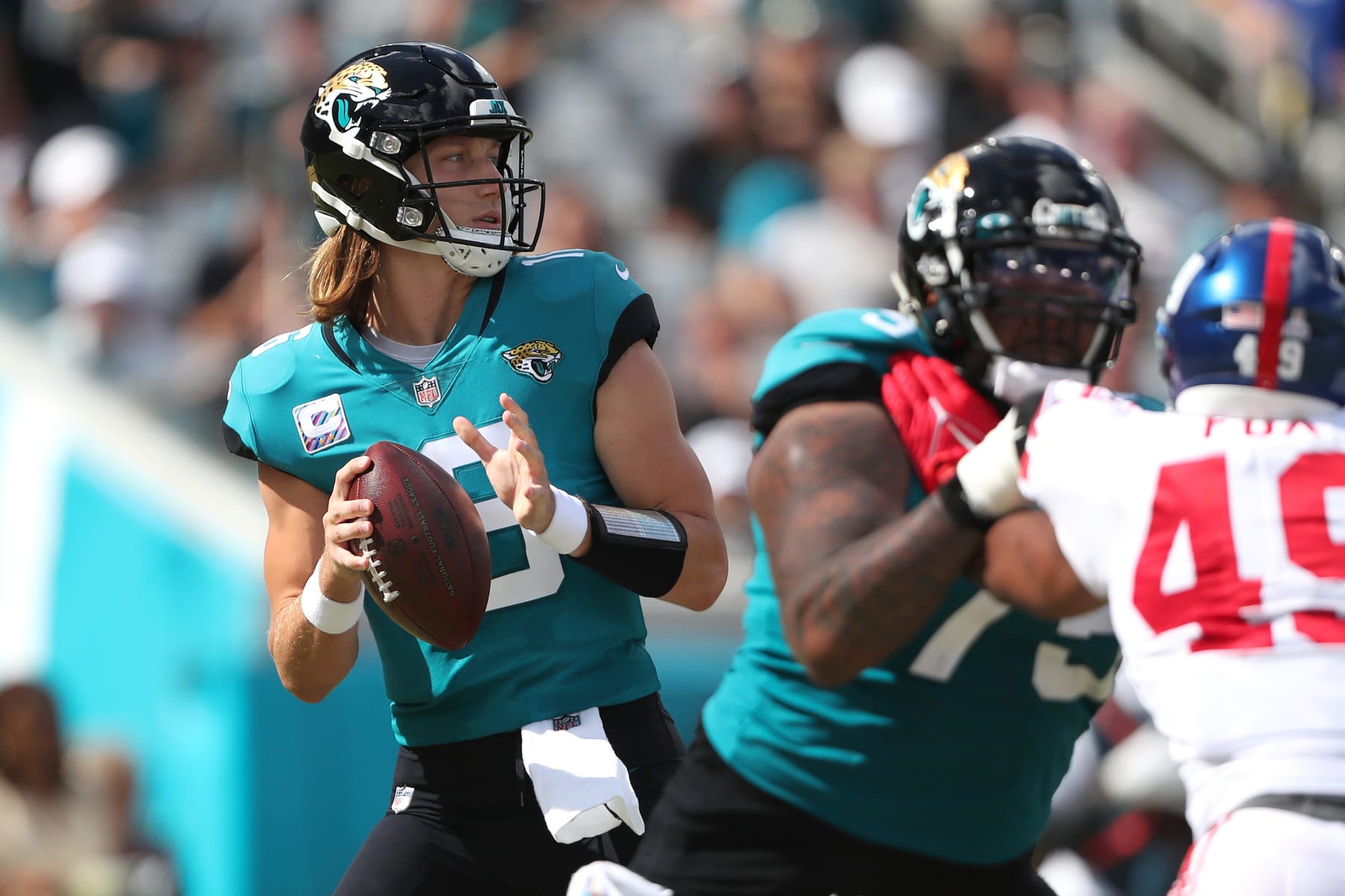 JACKSONVILLE, FLORIDA - OCTOBER 23: Trevor Lawrence #16 of the Jacksonville Jaguars drops back to pass during the first half against the New York Giants at TIAA Bank Field on October 23, 2022 in Jacksonville, Florida. (Photo by Courtney Culbreath/Getty Images)