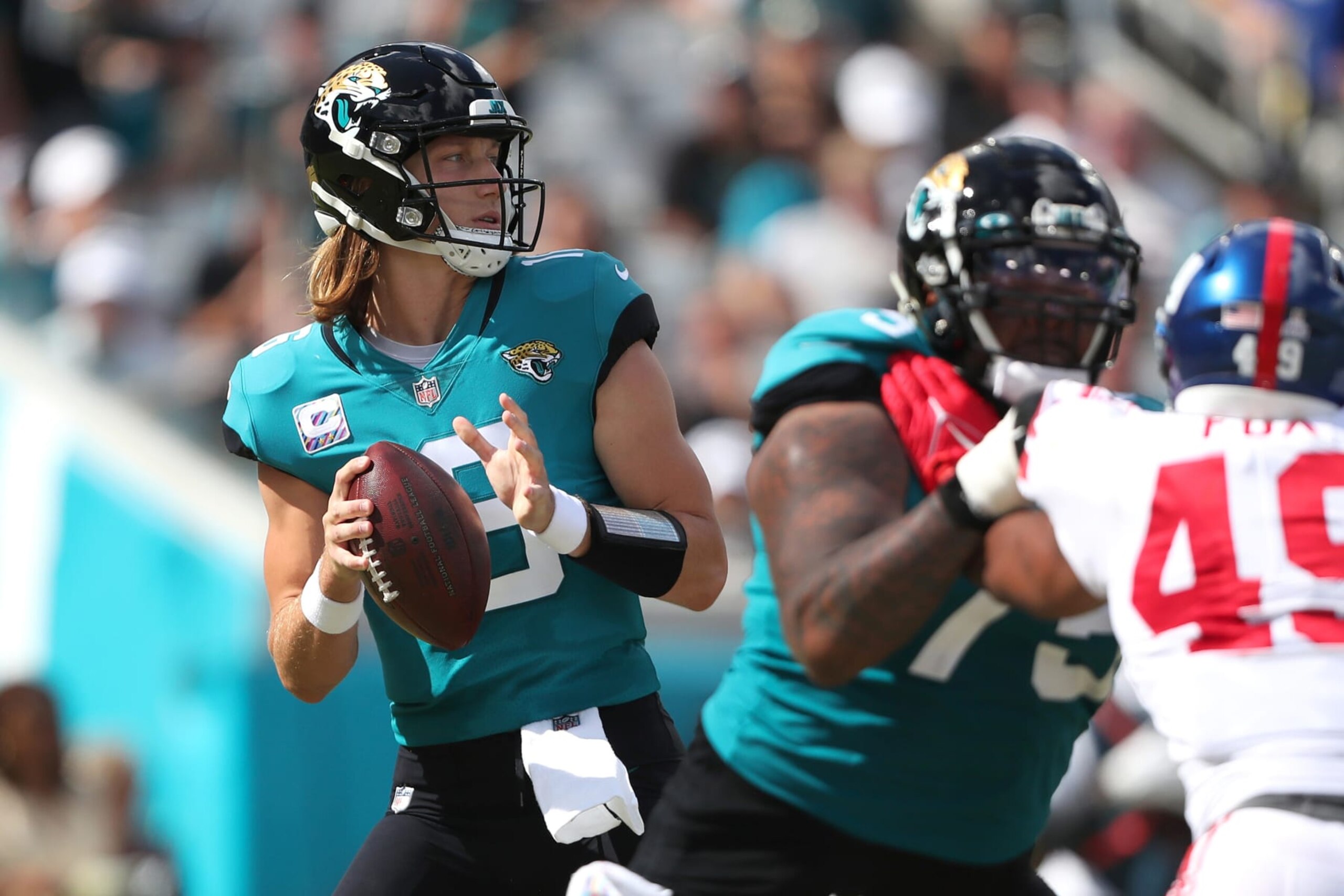 JACKSONVILLE, FLORIDA - OCTOBER 23: Trevor Lawrence #16 of the Jacksonville Jaguars drops back to pass during the first half against the New York Giants at TIAA Bank Field on October 23, 2022 in Jacksonville, Florida. (Photo by Courtney Culbreath/Getty Images)