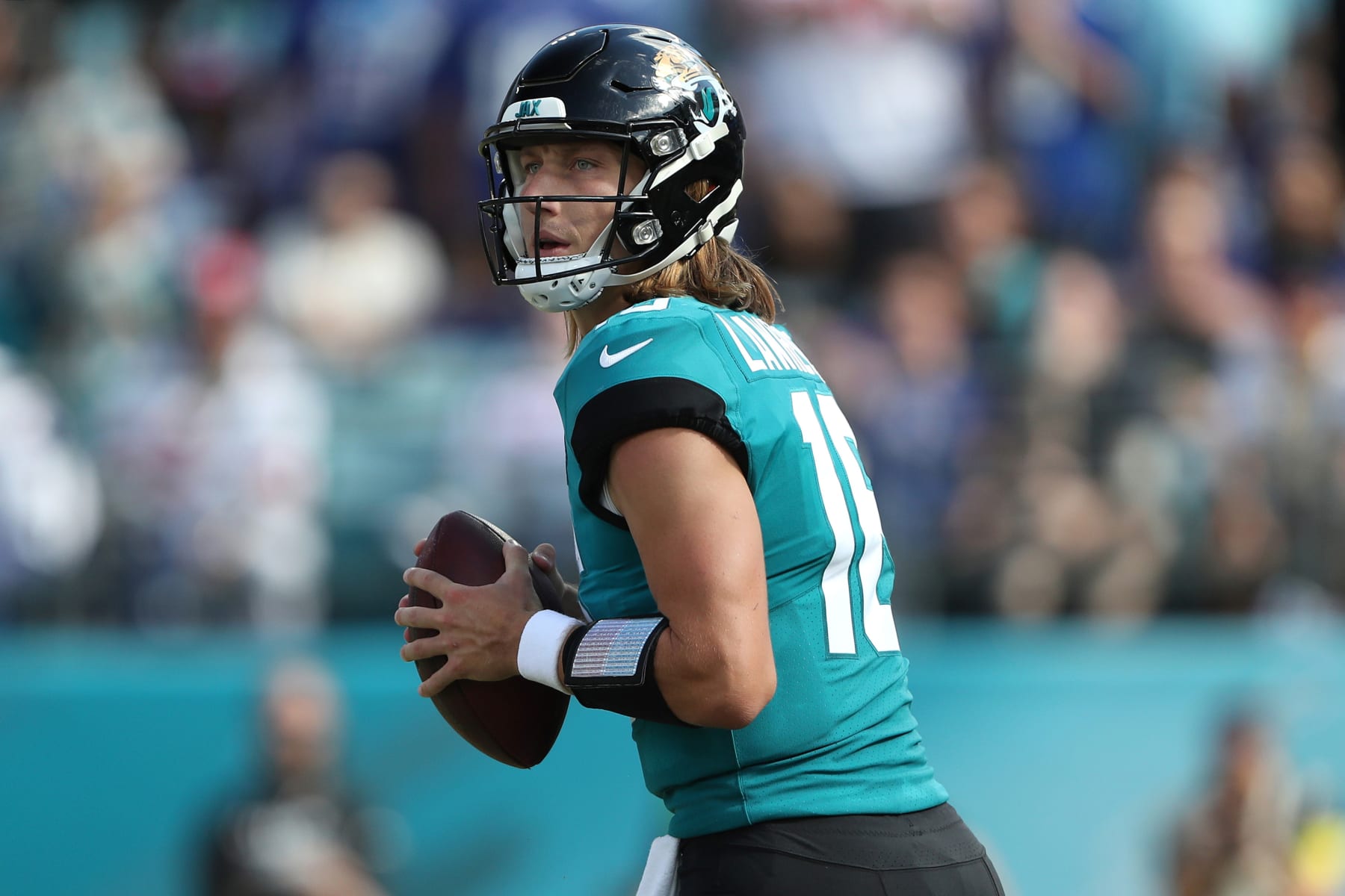 JACKSONVILLE, FLORIDA - OCTOBER 23: Trevor Lawrence #16 of the Jacksonville Jaguars drops back to pass during the second half against the New York Giants at TIAA Bank Field on October 23, 2022 in Jacksonville, Florida. (Photo by Courtney Culbreath/Getty Images)