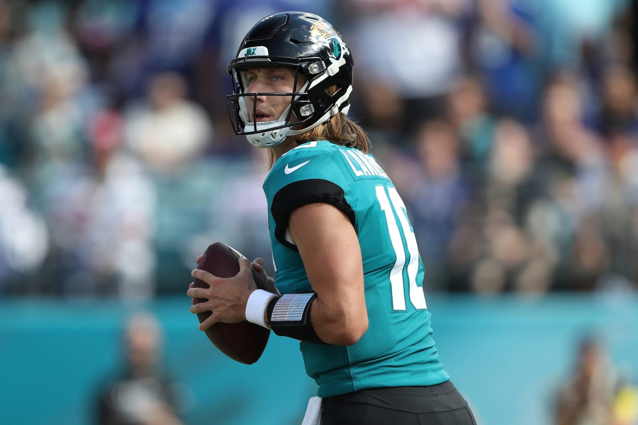 JACKSONVILLE, FLORIDA - OCTOBER 23: Trevor Lawrence #16 of the Jacksonville Jaguars drops back to pass during the second half against the New York Giants at TIAA Bank Field on October 23, 2022 in Jacksonville, Florida. (Photo by Courtney Culbreath/Getty Images)