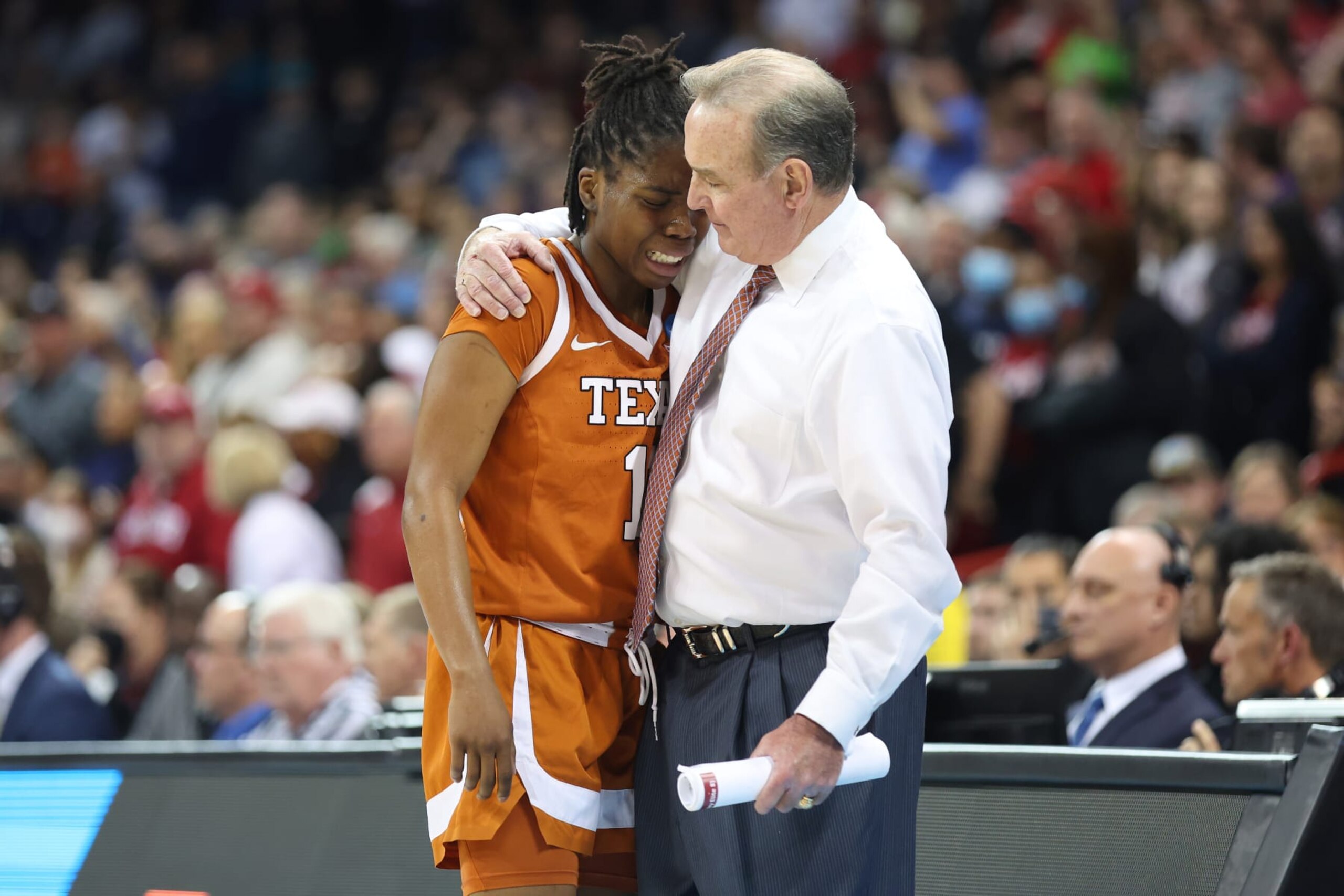 SPOKANE, WASHINGTON - MARCH 27: Head coach Vic Schaefer of the Texas Longhorns consoles Joanne Allen-Taylor #11 after she fouls out during the fourth quarter against the Stanford Cardinal in the NCAA Women's Basketball Tournament Elite 8 Round at Spokane Veterans Memorial Arena on March 27, 2022 in Spokane, Washington. (Photo by Abbie Parr/Getty Images)