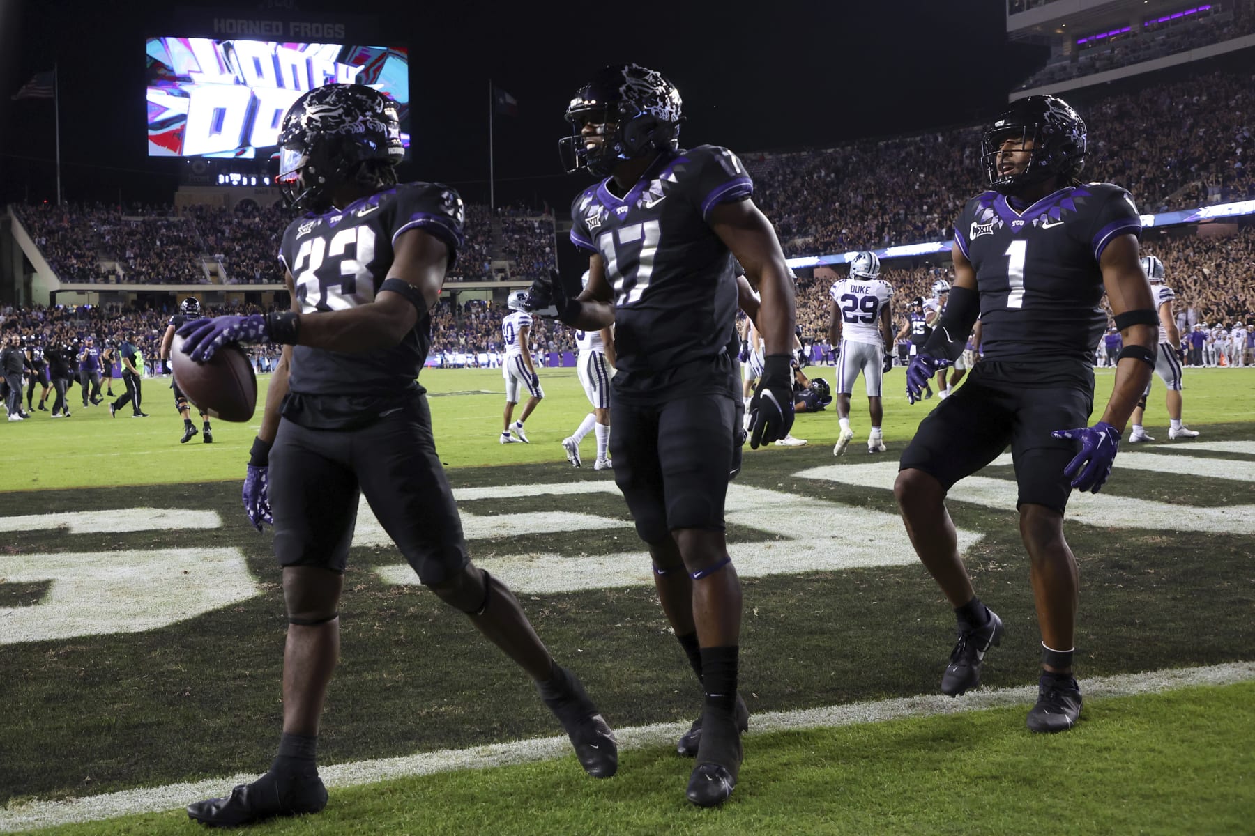 Kendre Miller (far left) celebrates a touchdown.