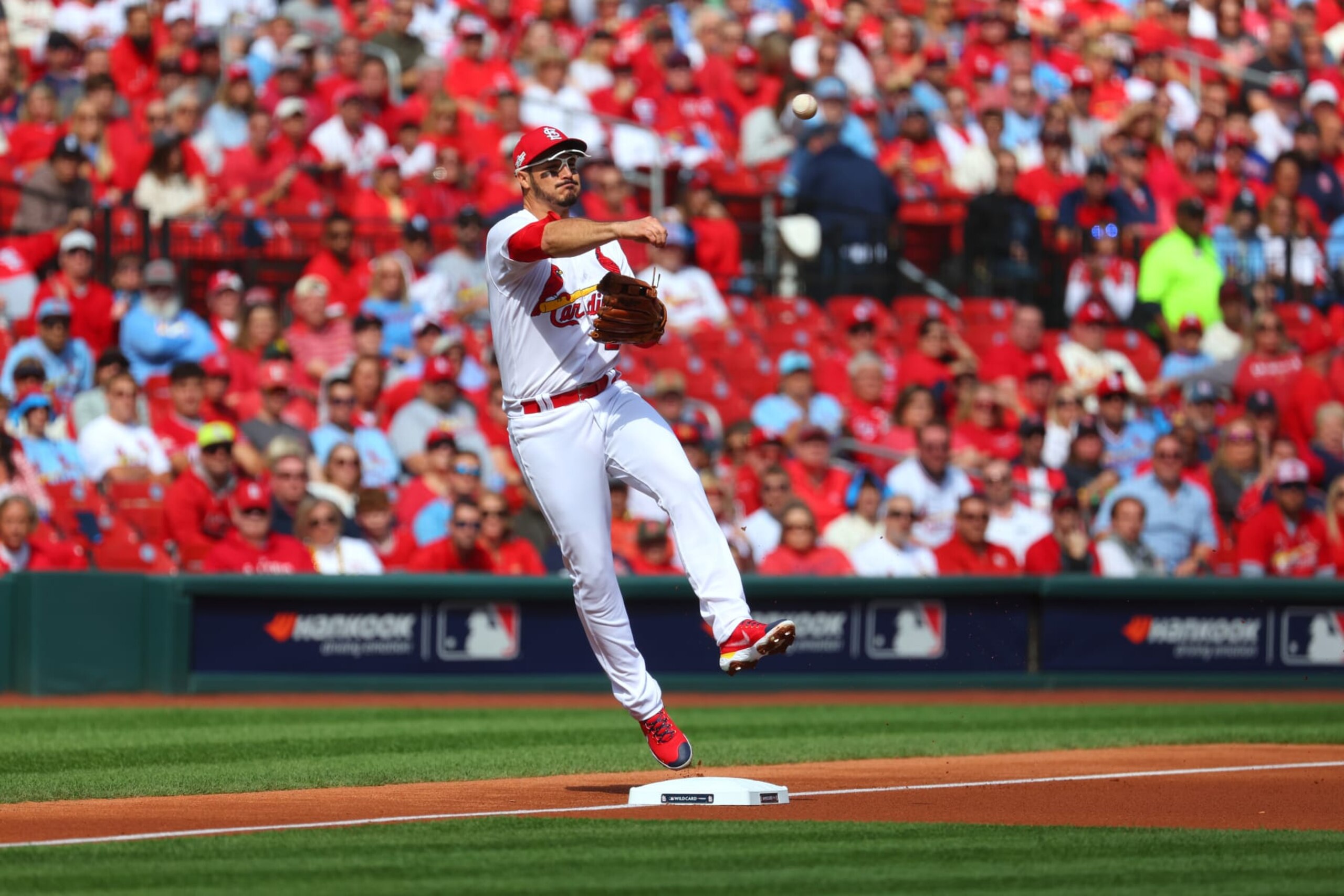 ST. LOUIS, MO - OCTOBER 07:  Nolan Arenado #28 of the St. Louis Cardinals throws to first base for an out in the first inning during the Wild Card Series game between the Philadelphia Phillies and the St. Louis Cardinals at Busch Stadium on Friday, October 7, 2022 in St. Louis, Missouri. (Photo by Dilip Vishwanat/MLB Photos via Getty Images)