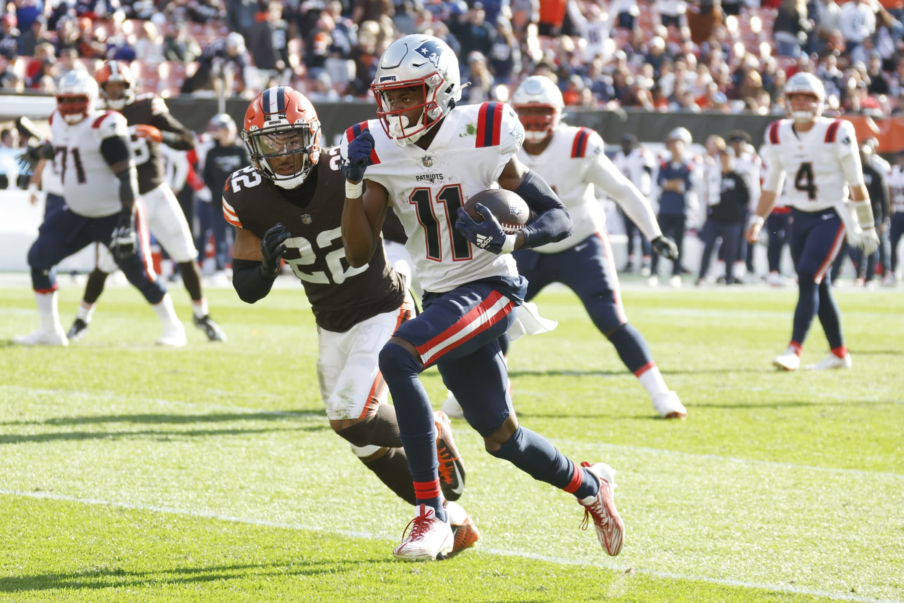 New England Patriots wide receiver Tyquan Thornton (11) runs past Cleveland Browns safety Grant Delpit (22) on his way to a touchdown after making catch during the second half an NFL football game, Sunday, Oct. 16, 2022, in Cleveland. (AP Photo/Ron Schwane)