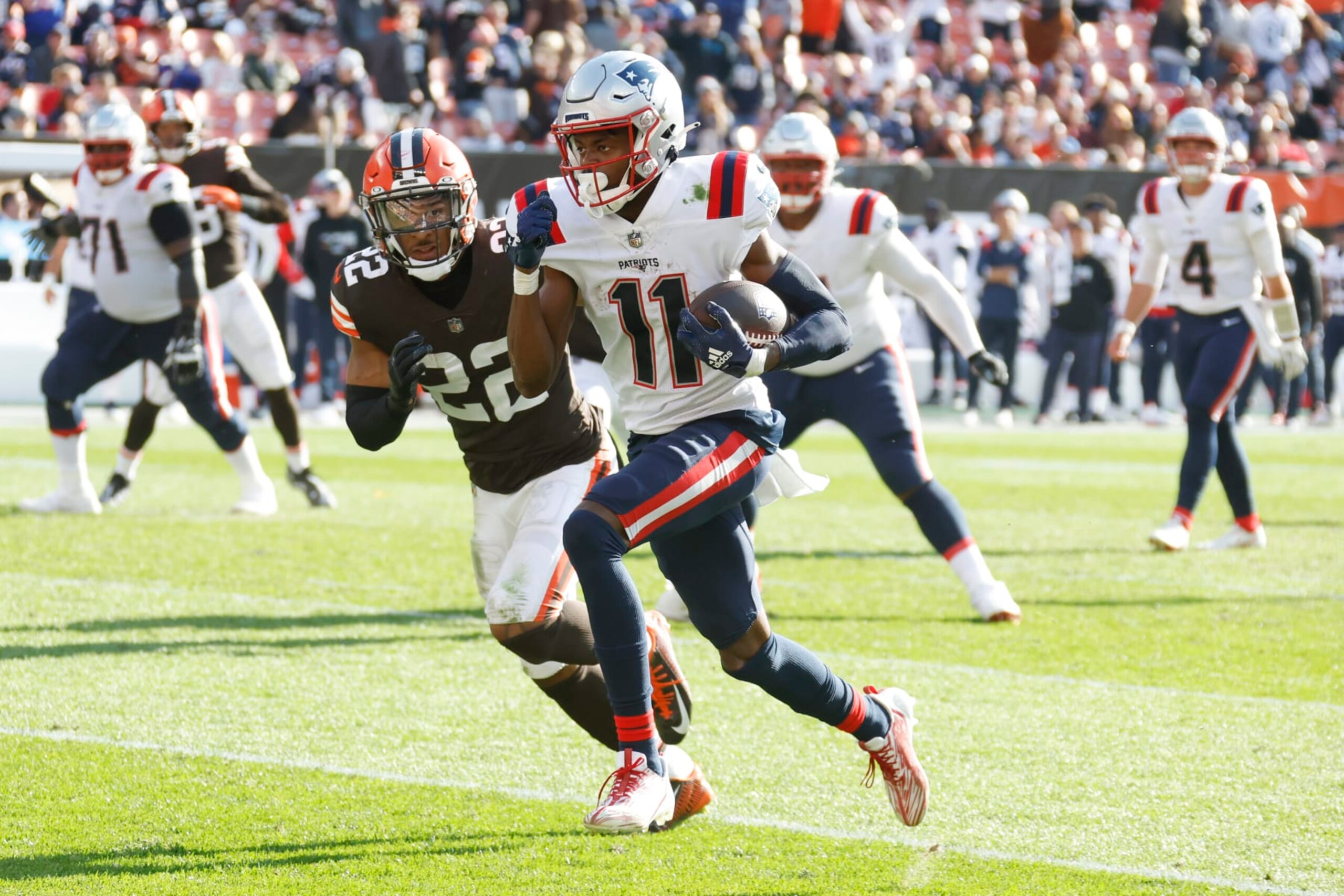 New England Patriots wide receiver Tyquan Thornton (11) runs past Cleveland Browns safety Grant Delpit (22) on his way to a touchdown after making catch during the second half an NFL football game, Sunday, Oct. 16, 2022, in Cleveland. (AP Photo/Ron Schwane)