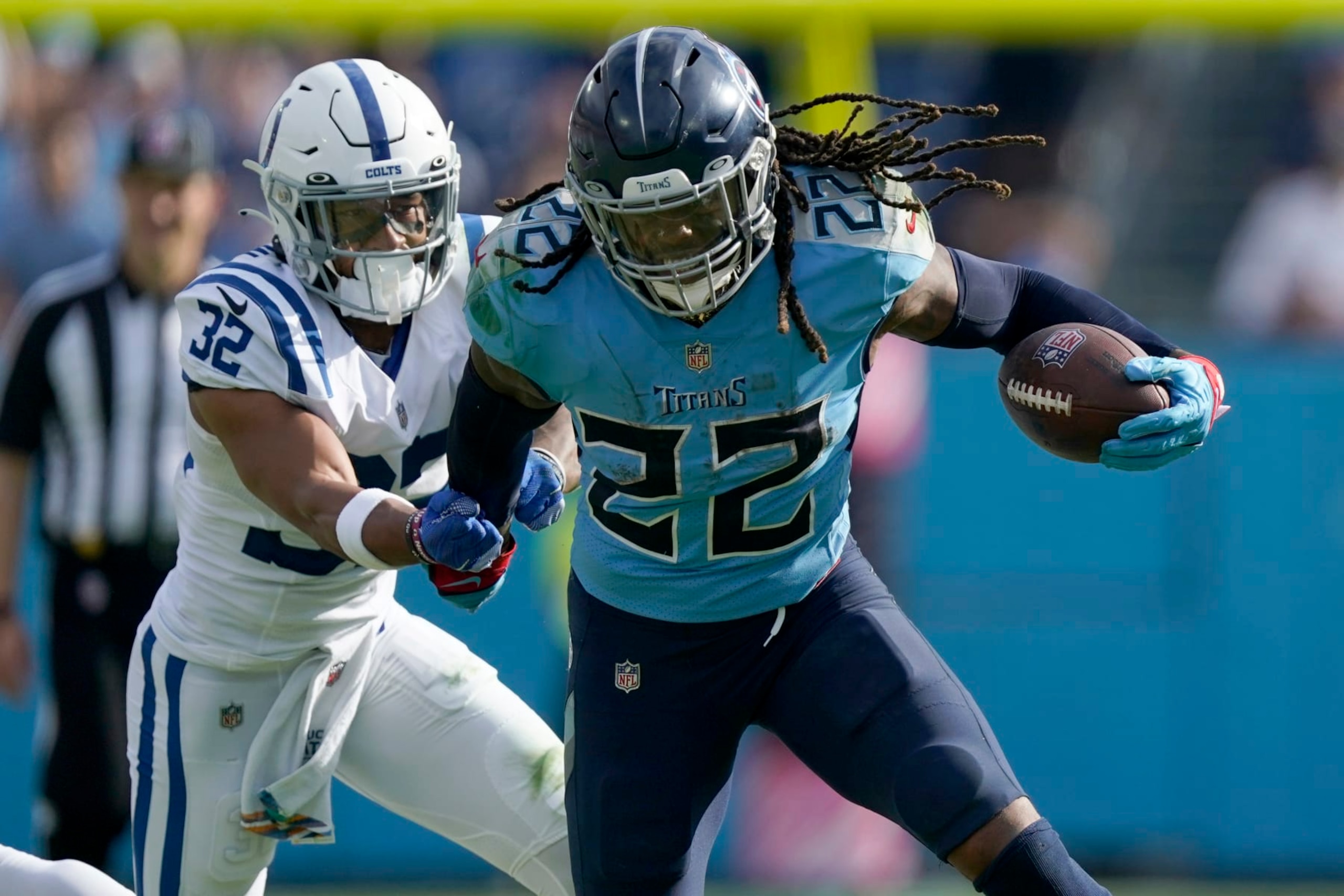 Tennessee Titans running back Derrick Henry (22) runs with the ball as Indianapolis Colts safety Julian Blackmon (32) defends during the second half of an NFL football game Sunday, Oct. 23, 2022, in Nashville, Tenn. (AP Photo/Mark Humphrey)