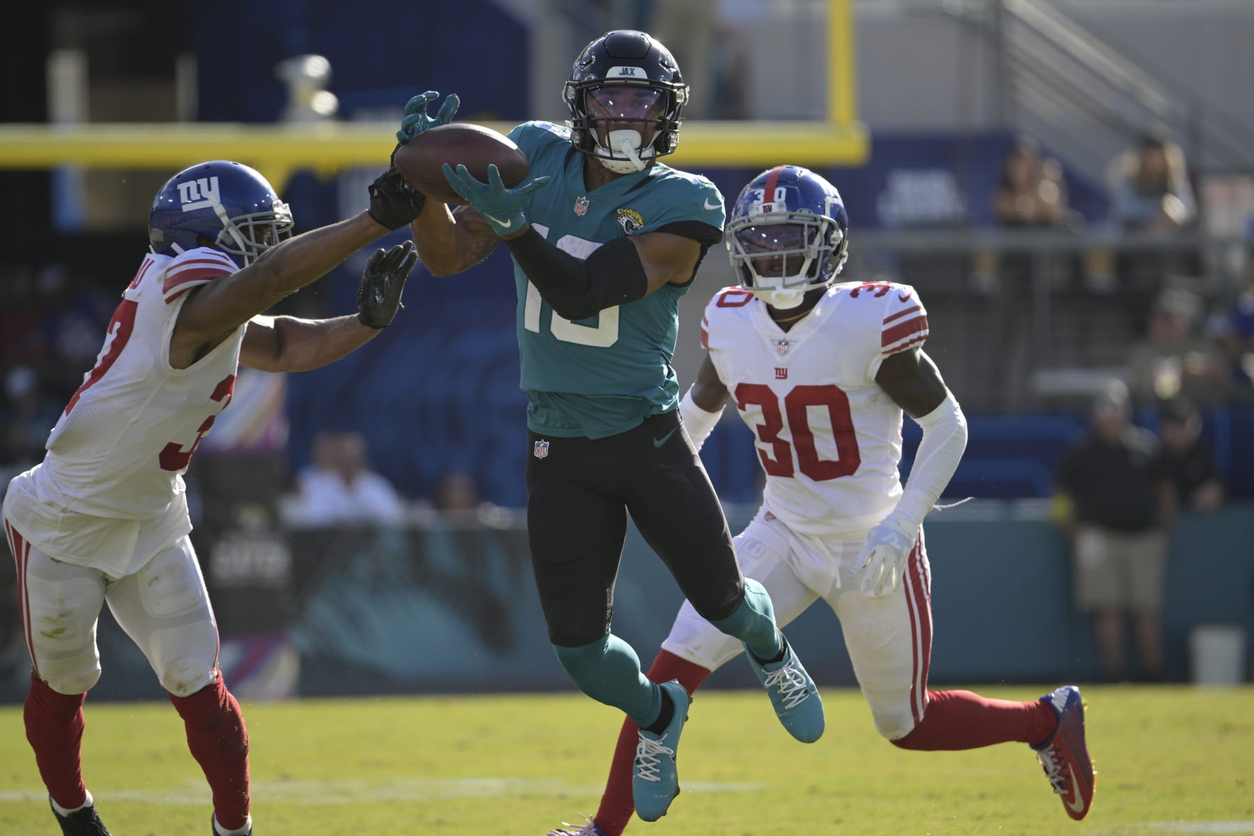 New York Giants cornerback Fabian Moreau (37) breaks up a pass intended for Jacksonville Jaguars wide receiver Christian Kirk (13) during the second half of an NFL football game Sunday, Oct. 23, 2022, in Jacksonville, Fla. (AP Photo/Phelan M. Ebenhack)