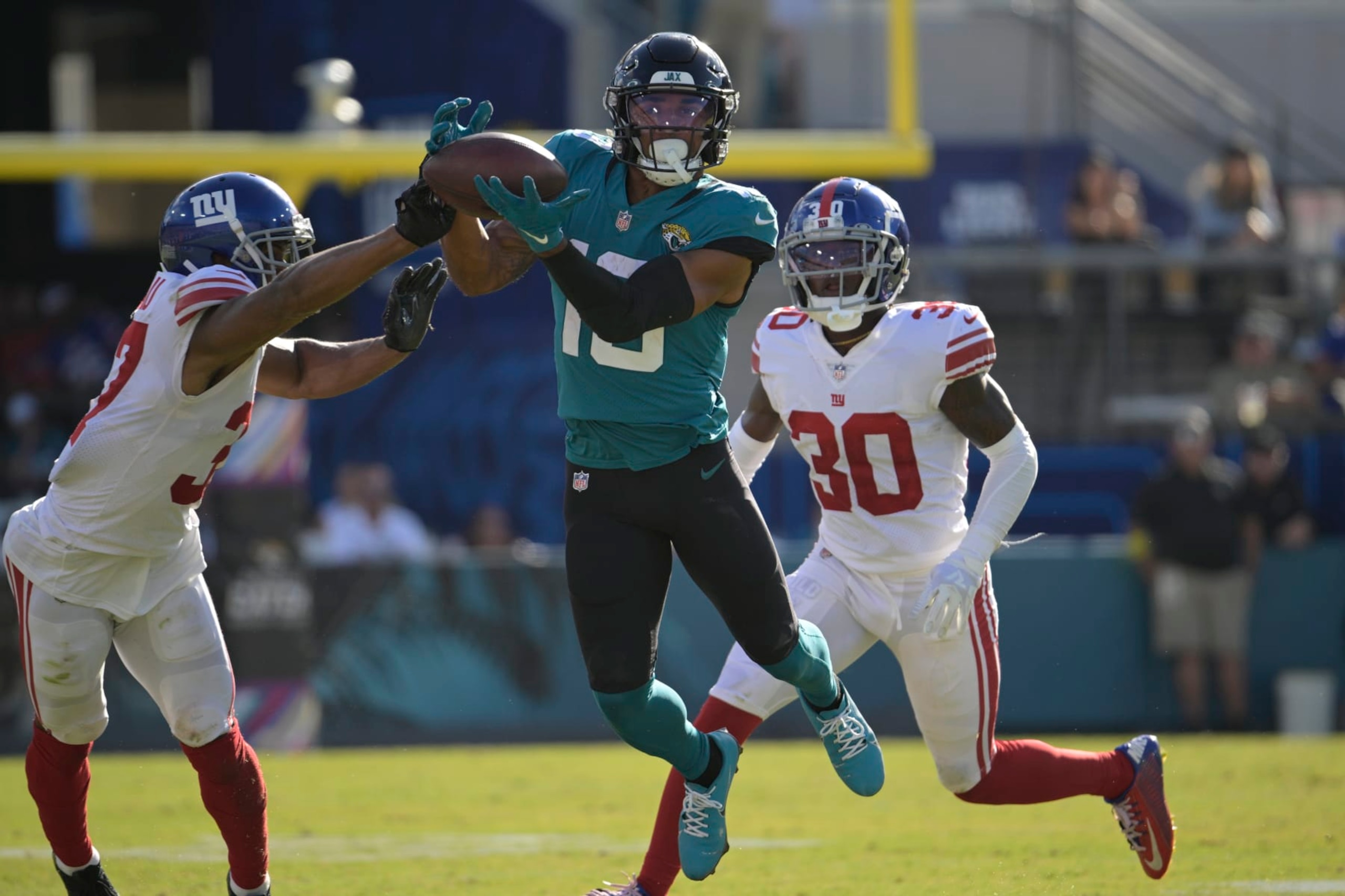 New York Giants cornerback Fabian Moreau (37) breaks up a pass intended for Jacksonville Jaguars wide receiver Christian Kirk (13) during the second half of an NFL football game Sunday, Oct. 23, 2022, in Jacksonville, Fla. (AP Photo/Phelan M. Ebenhack)