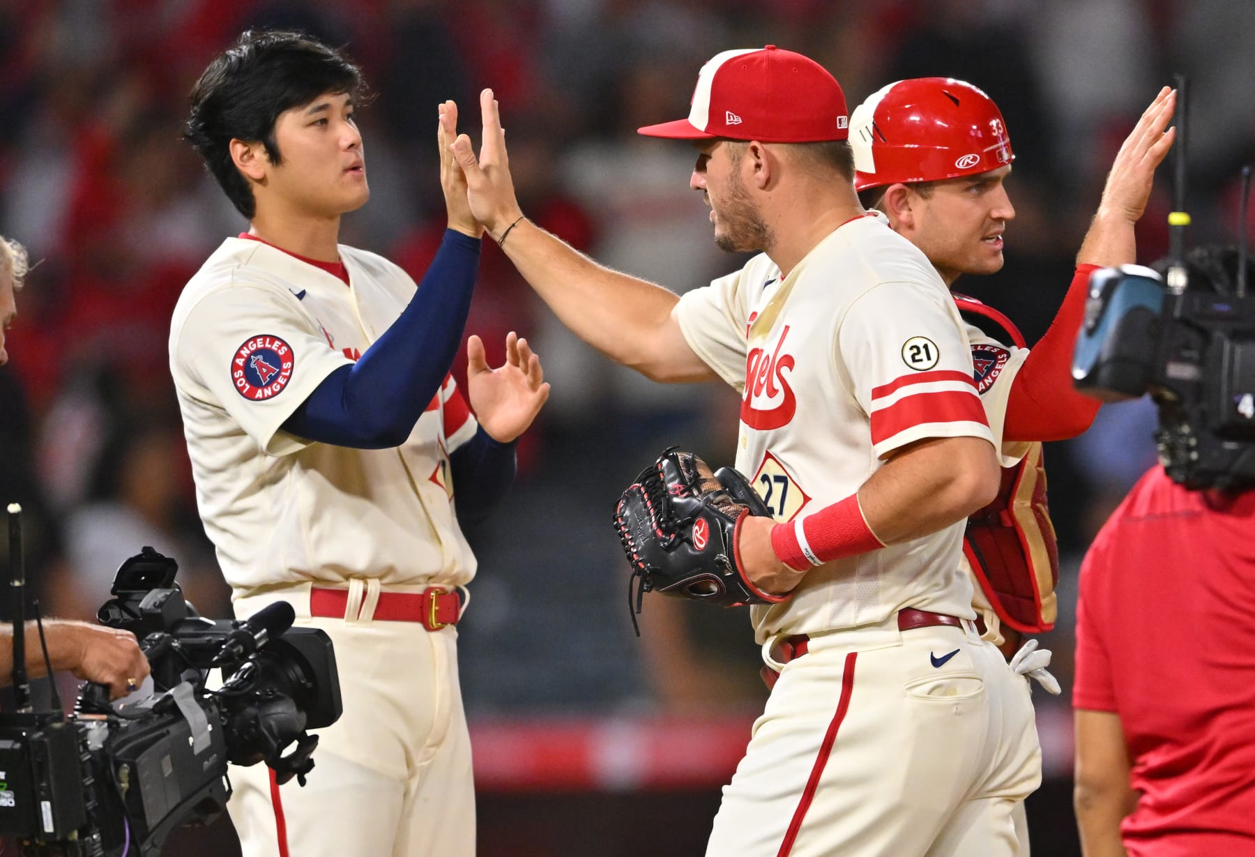 ANAHEIM, CA - SEPTEMBER 16: Shohei Ohtani #17 and Mike Trout #27 of the Los Angeles Angels high five as they leave the field after the final out of the ninth inning defeating the Seattle Mariners at Angel Stadium of Anaheim on September 16, 2022 in Anaheim, California. (Photo by Jayne Kamin-Oncea/Getty Images)