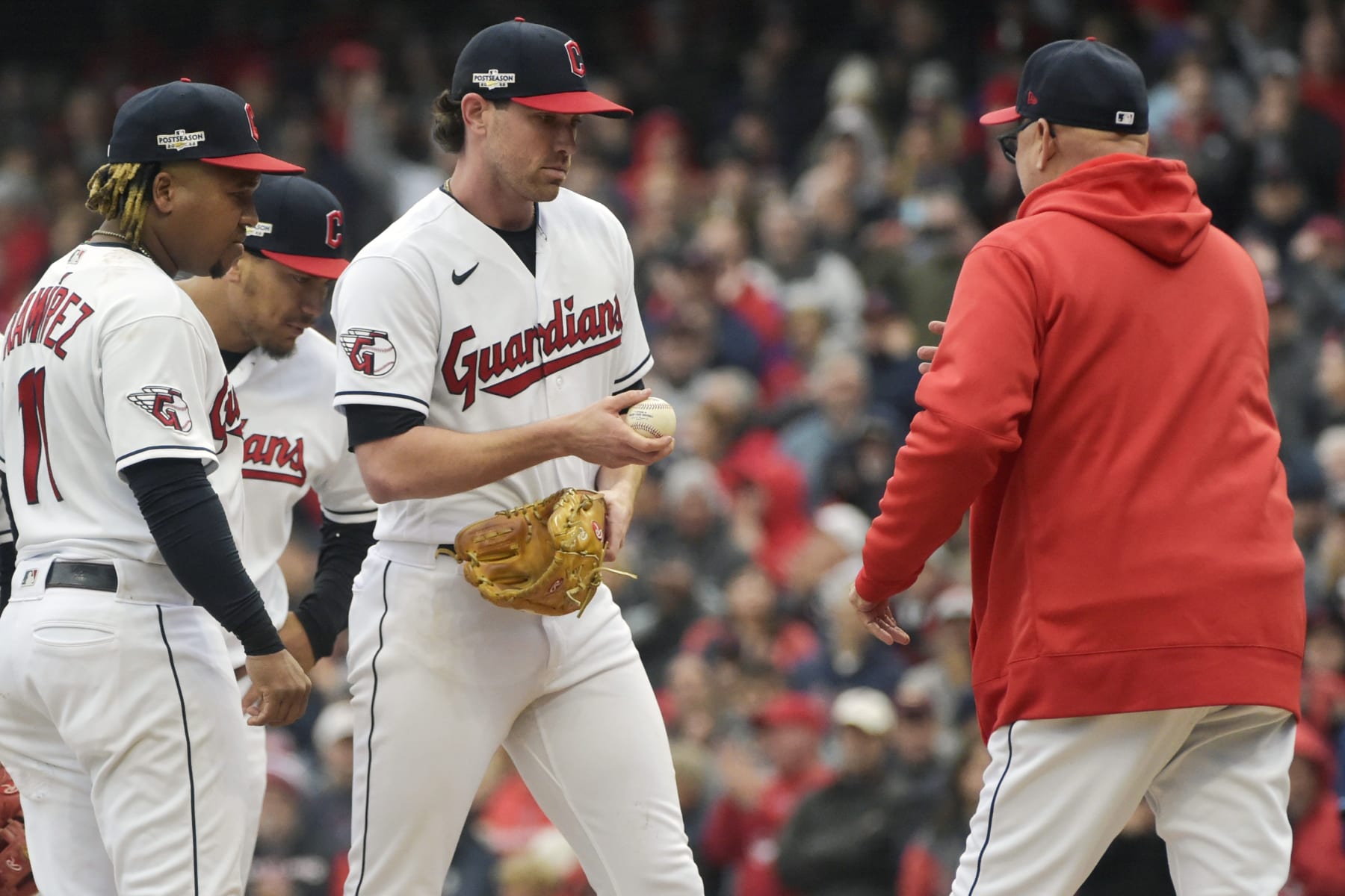 Cleveland Guardians manager Terry Francona, right, comes in to take starting pitcher Shane Bieber, center, out of the game in the eighth inning of a wild card baseball playoff game against the Tampa Bay Rays, Friday, Oct. 7, 2022, in Cleveland. Guardians' Jose Ramirez is at left. (AP Photo/Phil Long)