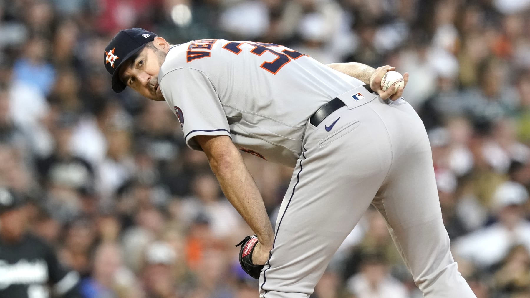 Houston Astros starting pitcher Justin Verlander checks the runner at first during a baseball game against the Chicago White Sox Tuesday, Aug. 16, 2022, in Chicago. (AP Photo/Charles Rex Arbogast)