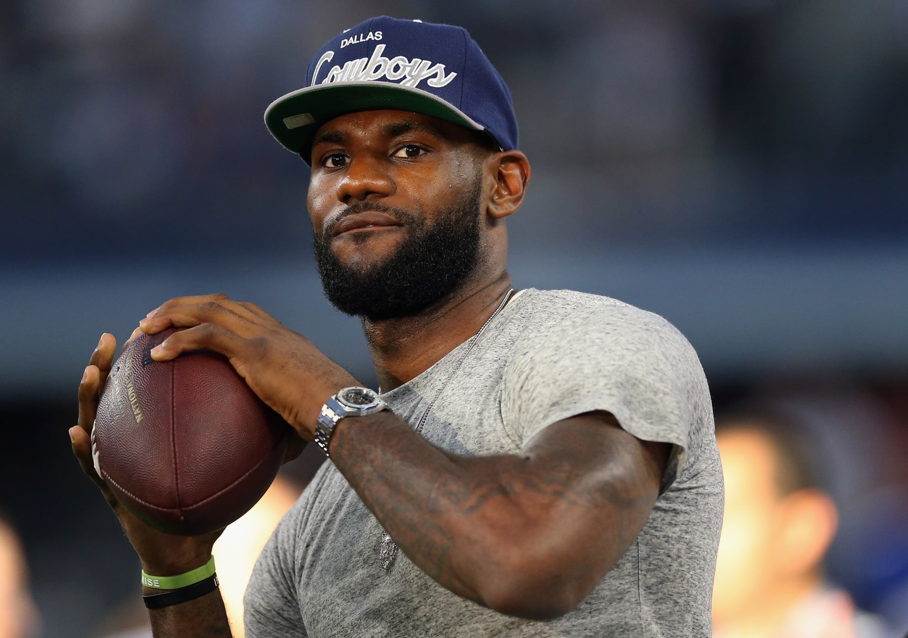 ARLINGTON, TX - SEPTEMBER 08:  NBA player Lebron James of the Miami Heat throws a football at AT&T Stadium before a Sunday night game between the New York Giants and the Dallas Cowboys on September 8, 2013 in Arlington, Texas.  (Photo by Ronald Martinez/Getty Images)