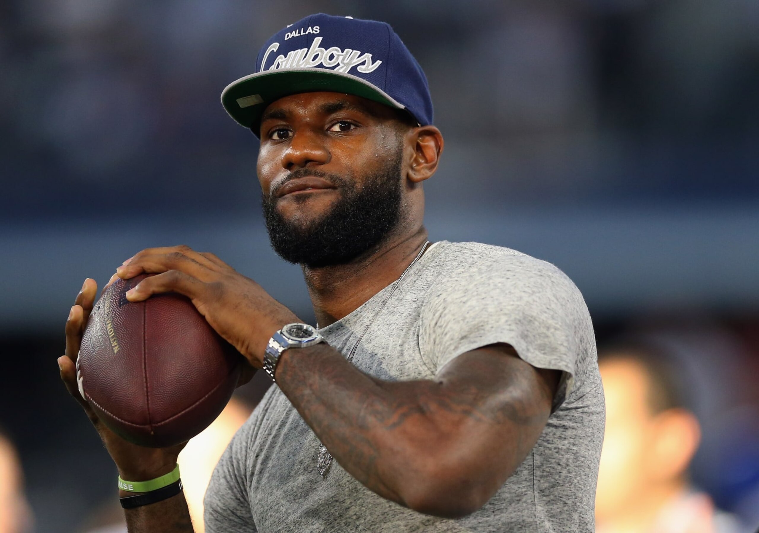 ARLINGTON, TX - SEPTEMBER 08:  NBA player Lebron James of the Miami Heat throws a football at AT&T Stadium before a Sunday night game between the New York Giants and the Dallas Cowboys on September 8, 2013 in Arlington, Texas.  (Photo by Ronald Martinez/Getty Images)