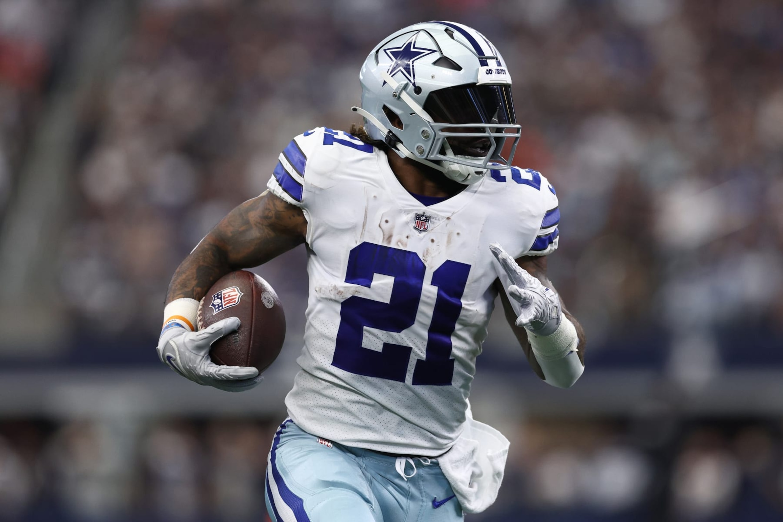 ARLINGTON, TEXAS - OCTOBER 23: Ezekiel Elliott #21 of the Dallas Cowboys runs with the ball against the Detroit Lions during the first half at AT&T Stadium on October 23, 2022 in Arlington, Texas. (Photo by Tom Pennington/Getty Images)