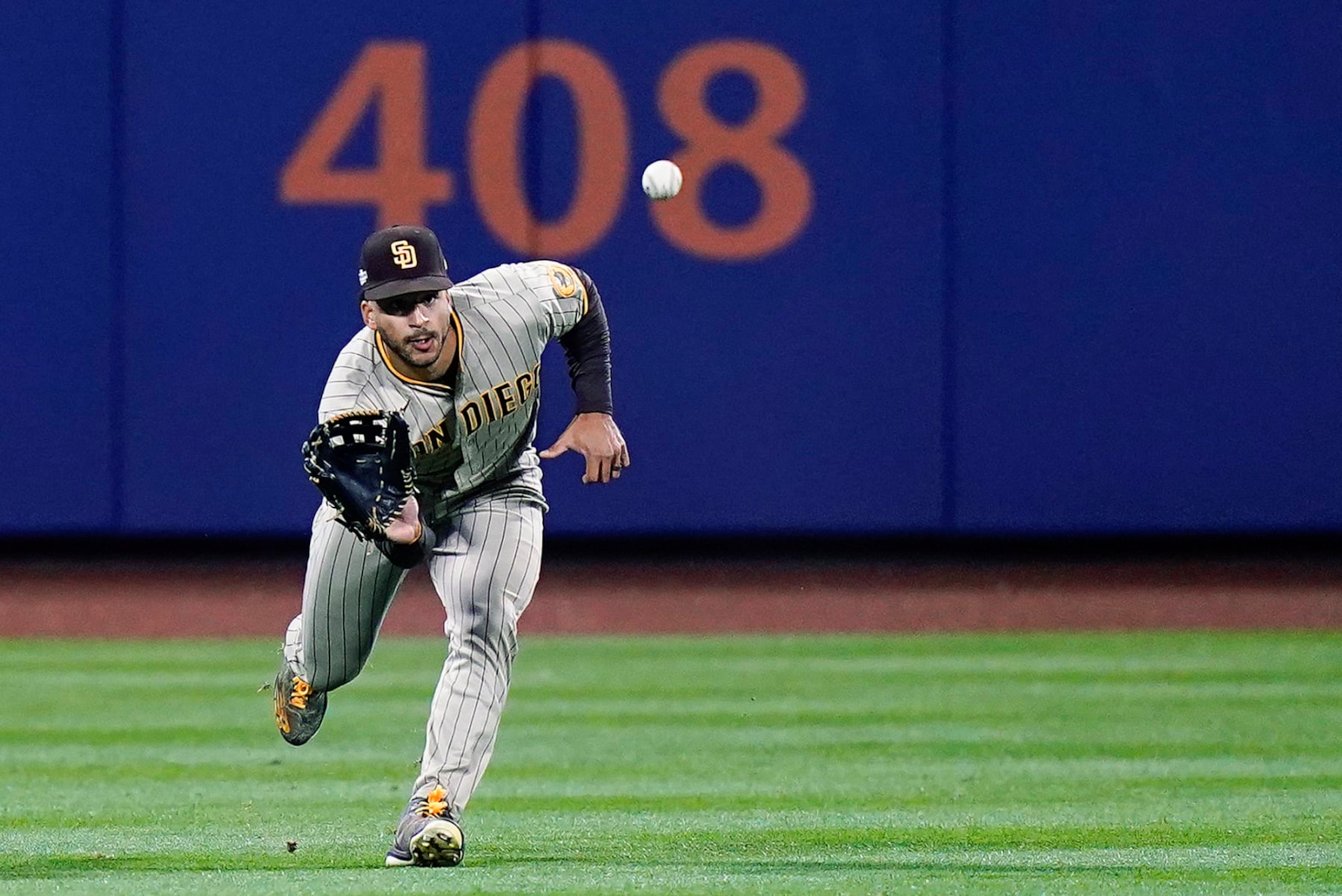 San Diego Padres center fielder Trent Grisham makes the catch on a line drive by New York Mets' Jeff McNeil during the fifth inning of Game 2 of an NL wild-card baseball playoff series Saturday, Oct. 8, 2022, in New York. (AP Photo/Frank Franklin II)