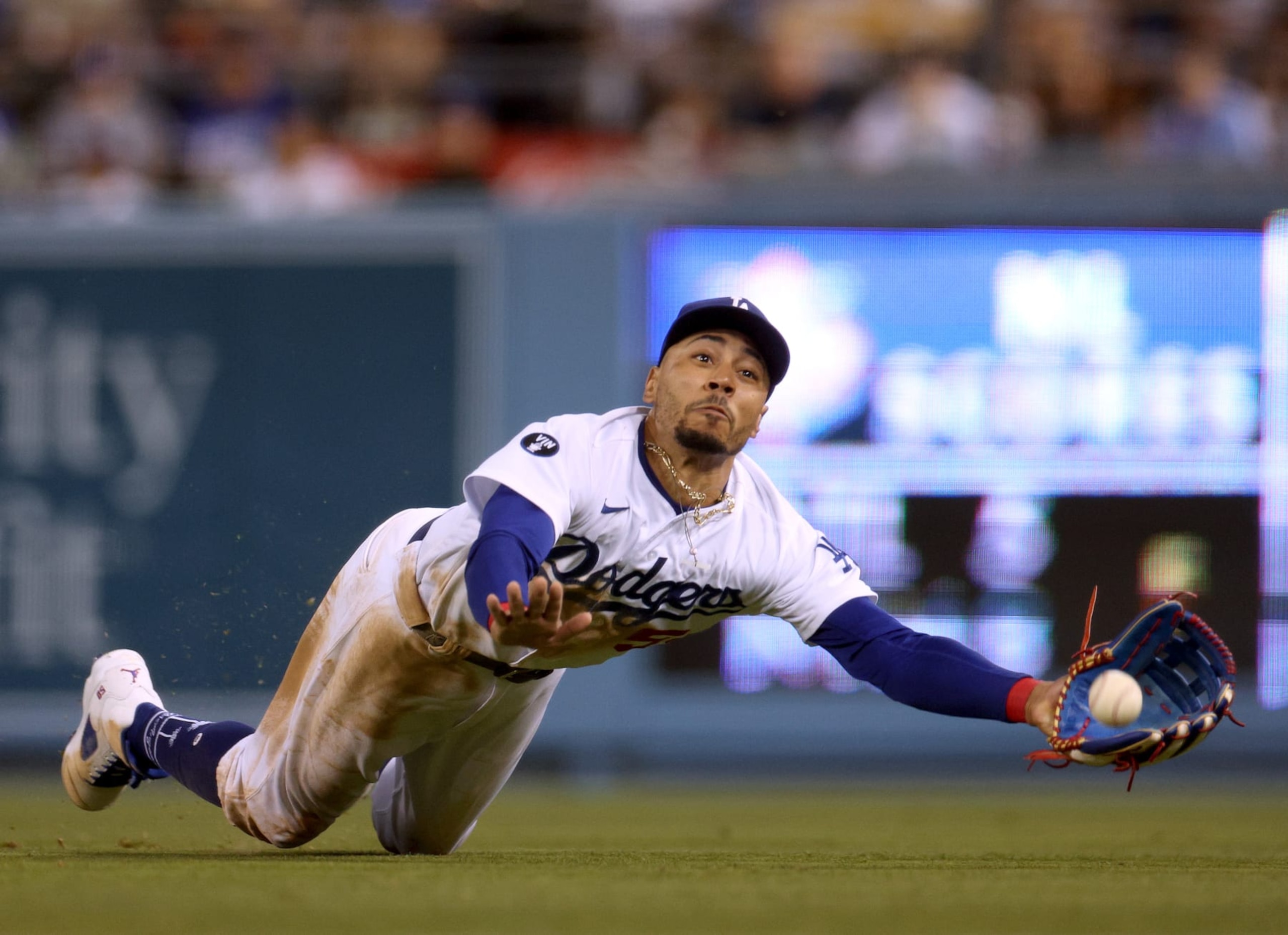LOS ANGELES, CALIFORNIA - AUGUST 06: Mookie Betts #50 of the Los Angeles Dodgers makes a diving attempt to catch a ball off the bat of Manny Machado #13 of the San Diego Padres during the eighth inning at Dodger Stadium on August 06, 2022 in Los Angeles, California. (Photo by Harry How/Getty Images)