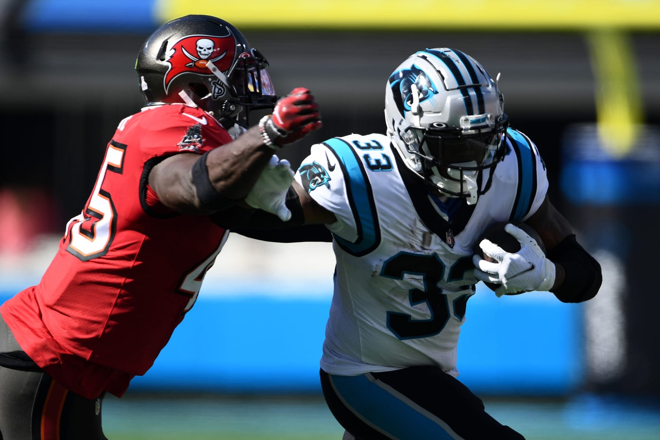 CHARLOTTE, NORTH CAROLINA - OCTOBER 23: Devin White #45 of the Tampa Bay Buccaneers tackles D'Onta Foreman #33 of the Carolina Panthers in the second quarter at Bank of America Stadium on October 23, 2022 in Charlotte, North Carolina. (Photo by Eakin Howard/Getty Images)