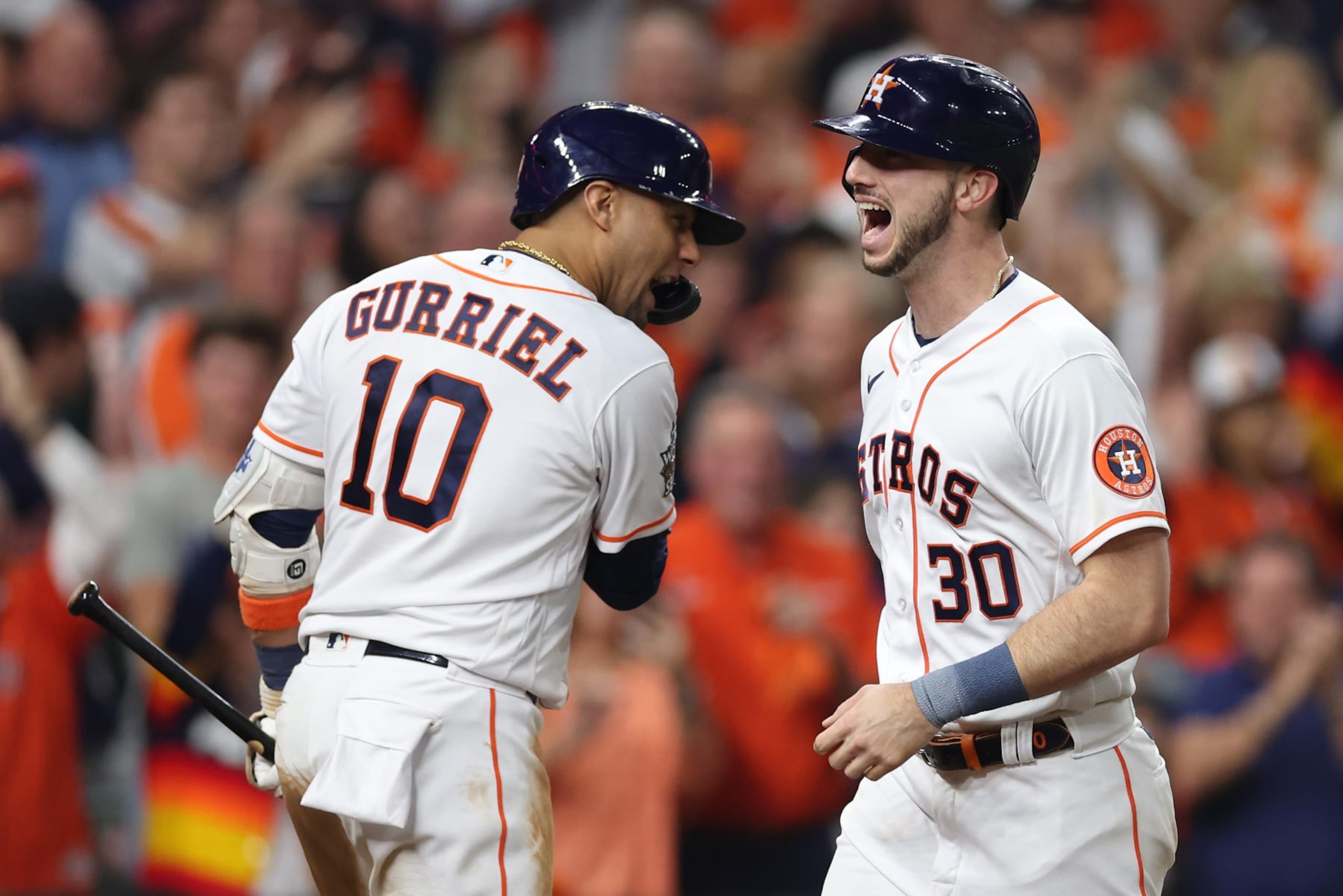 HOUSTON, TEXAS - OCTOBER 28: Yuli Gurriel #10 and Kyle Tucker #30 of the Houston Astros celebrate after Tucker hit a home run in the third inning against the Philadelphia Phillies in Game One of the 2022 World Series at Minute Maid Park on October 28, 2022 in Houston, Texas. (Photo by Sean M. Haffey/Getty Images)